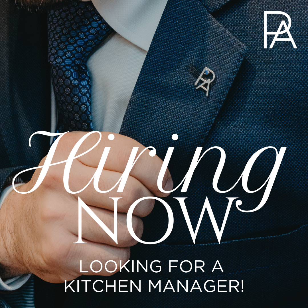 Blue Suit Jacket with PA Lapel Pin and a hand adjusting the breast of the coat