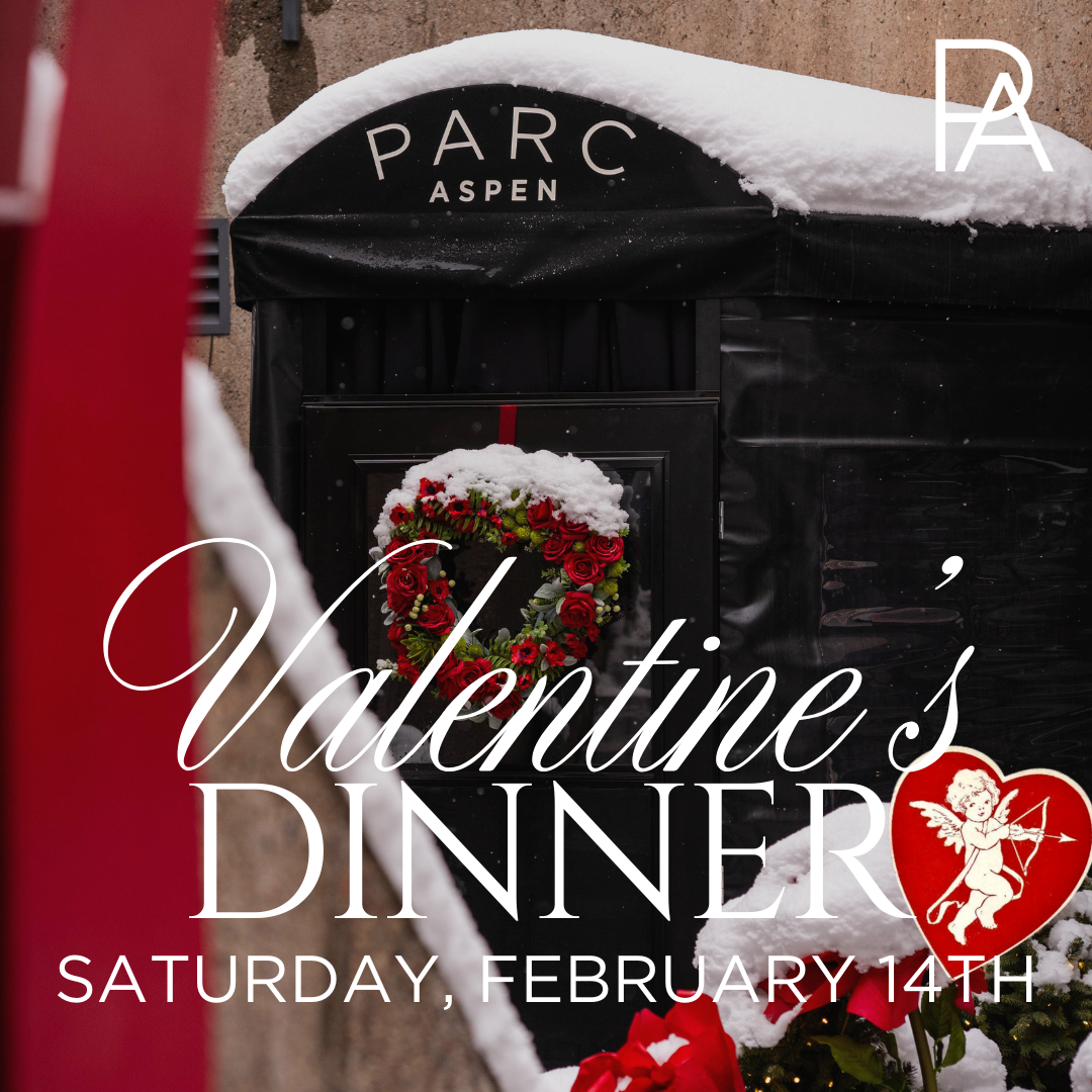 Front door with snow, a red floral heart and the logo PARC Aspen