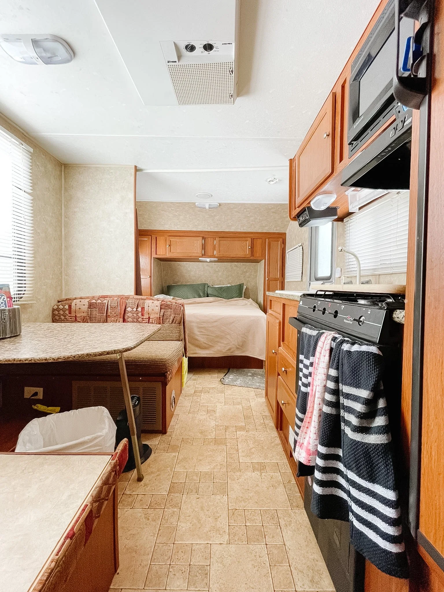 view of kitchen and bed before.jpg