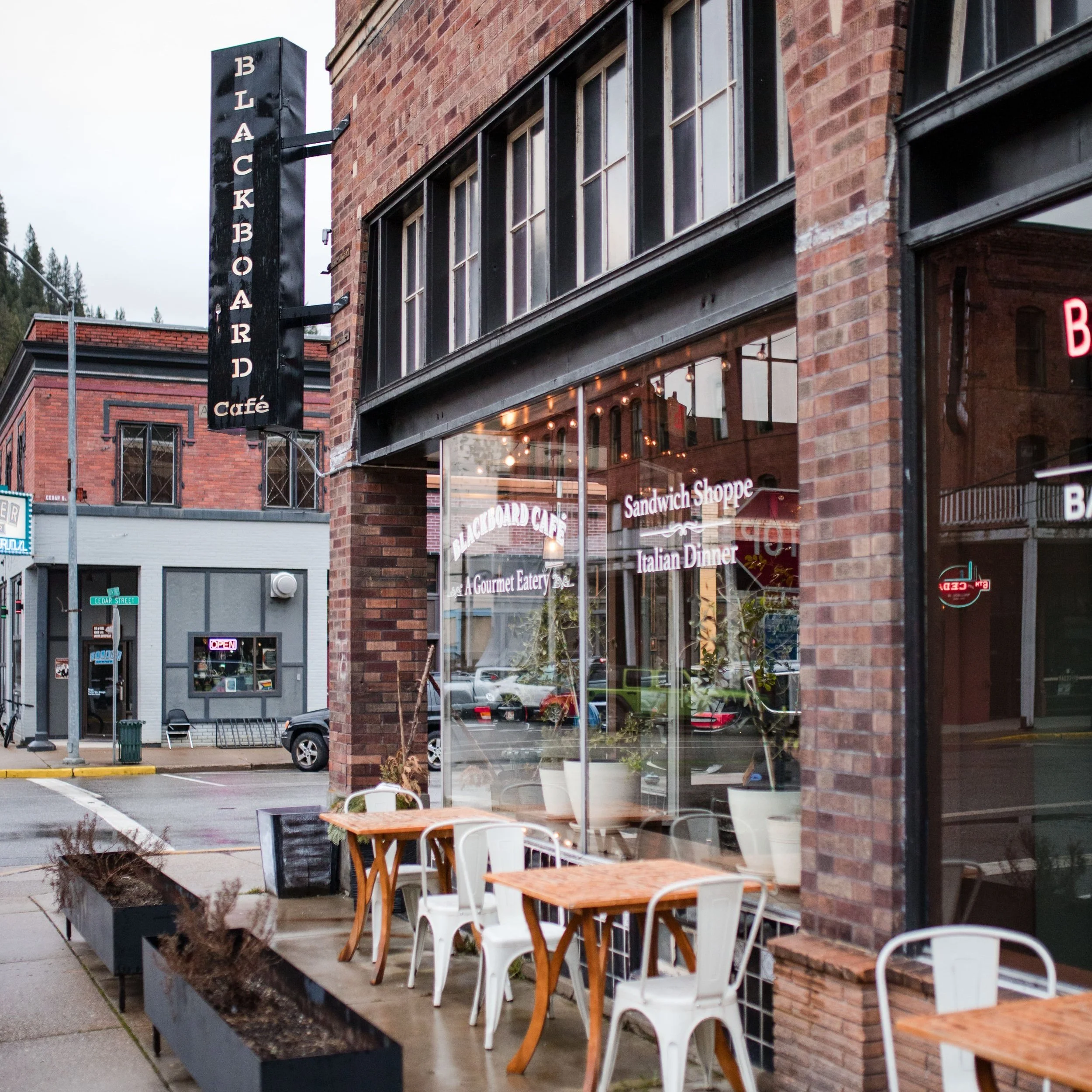 patio chairs and tables outside of a cafe
