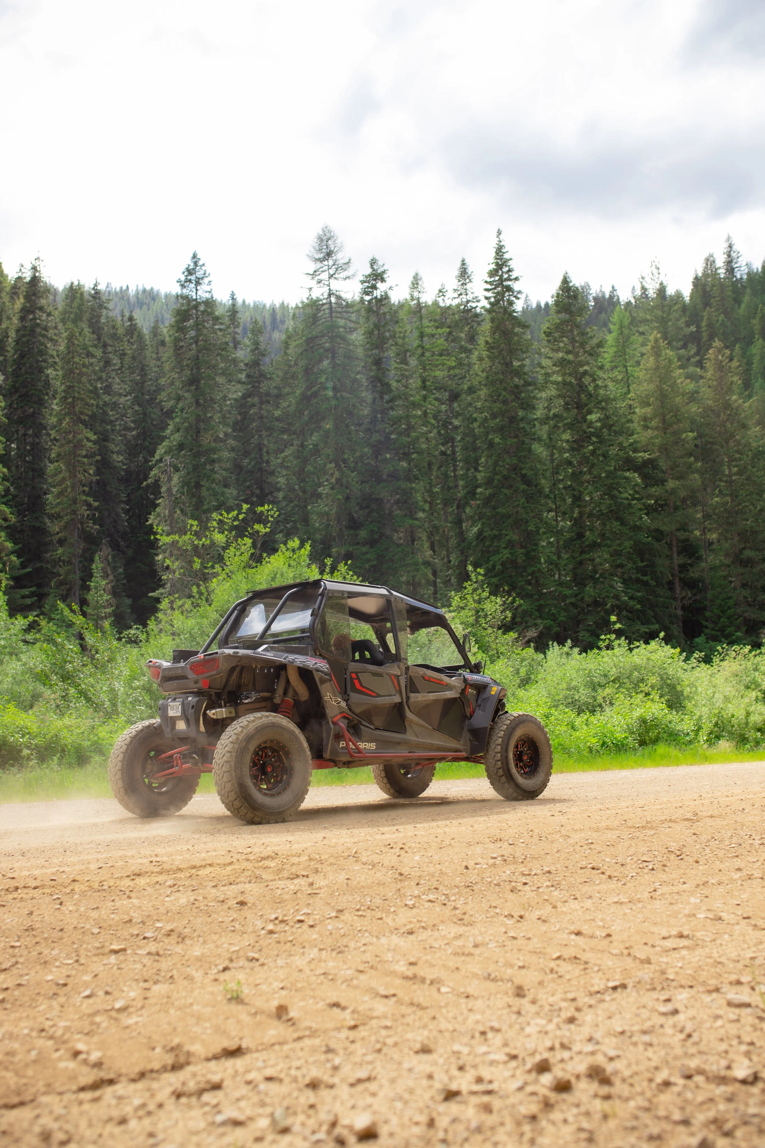 RZR vehicle on dirt road in the mountains