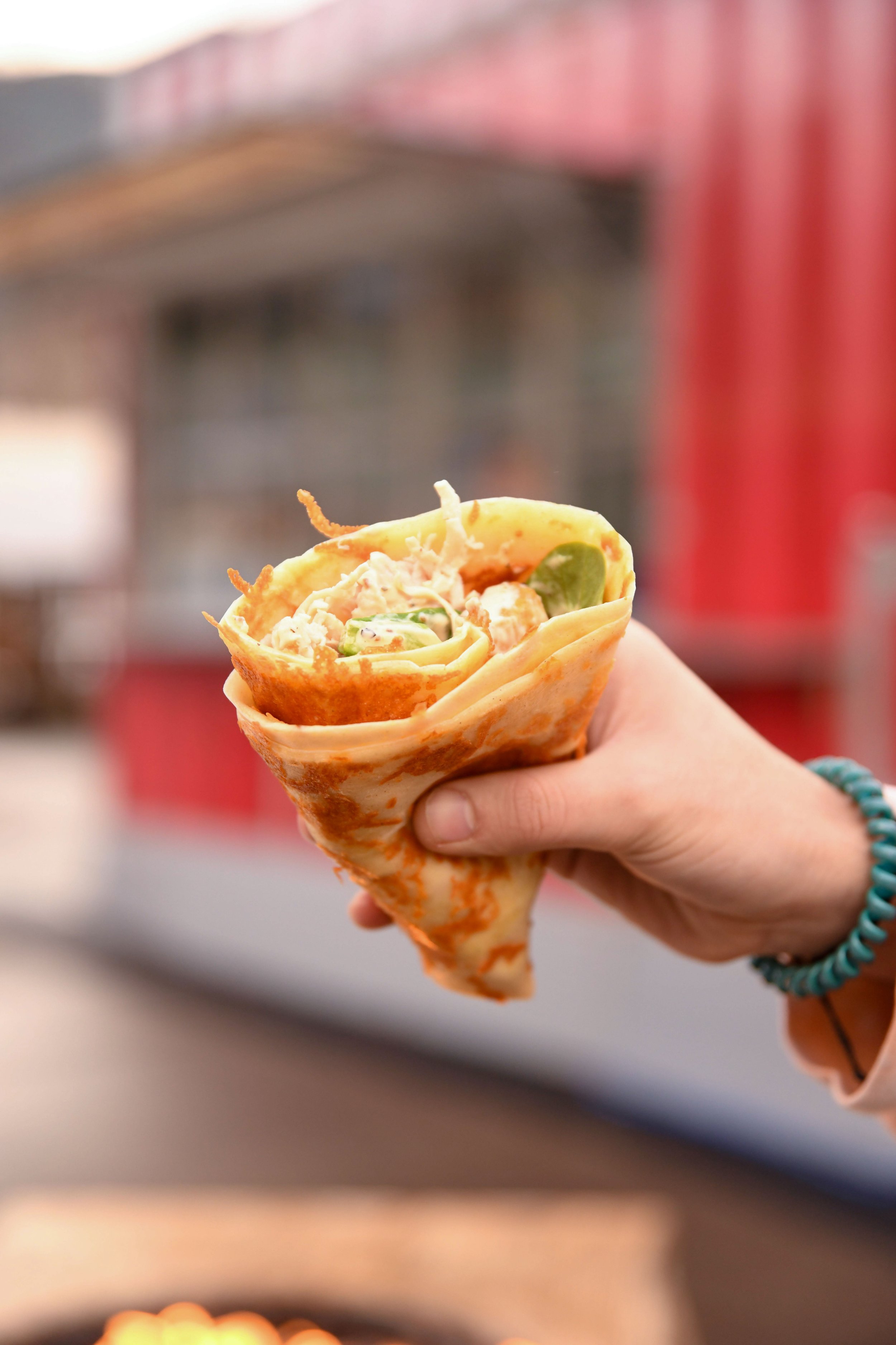 a delicous looking crepe being held in a hand