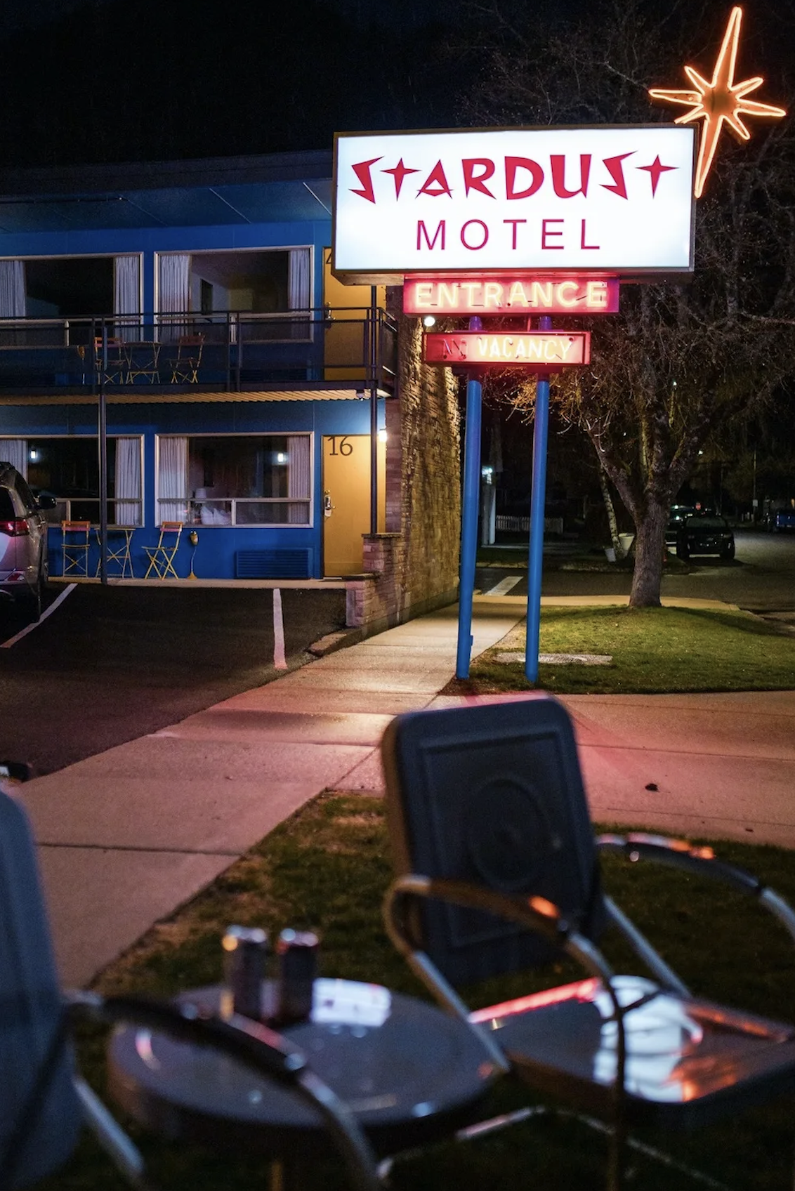 neon glowing signs with chairs in a lawn