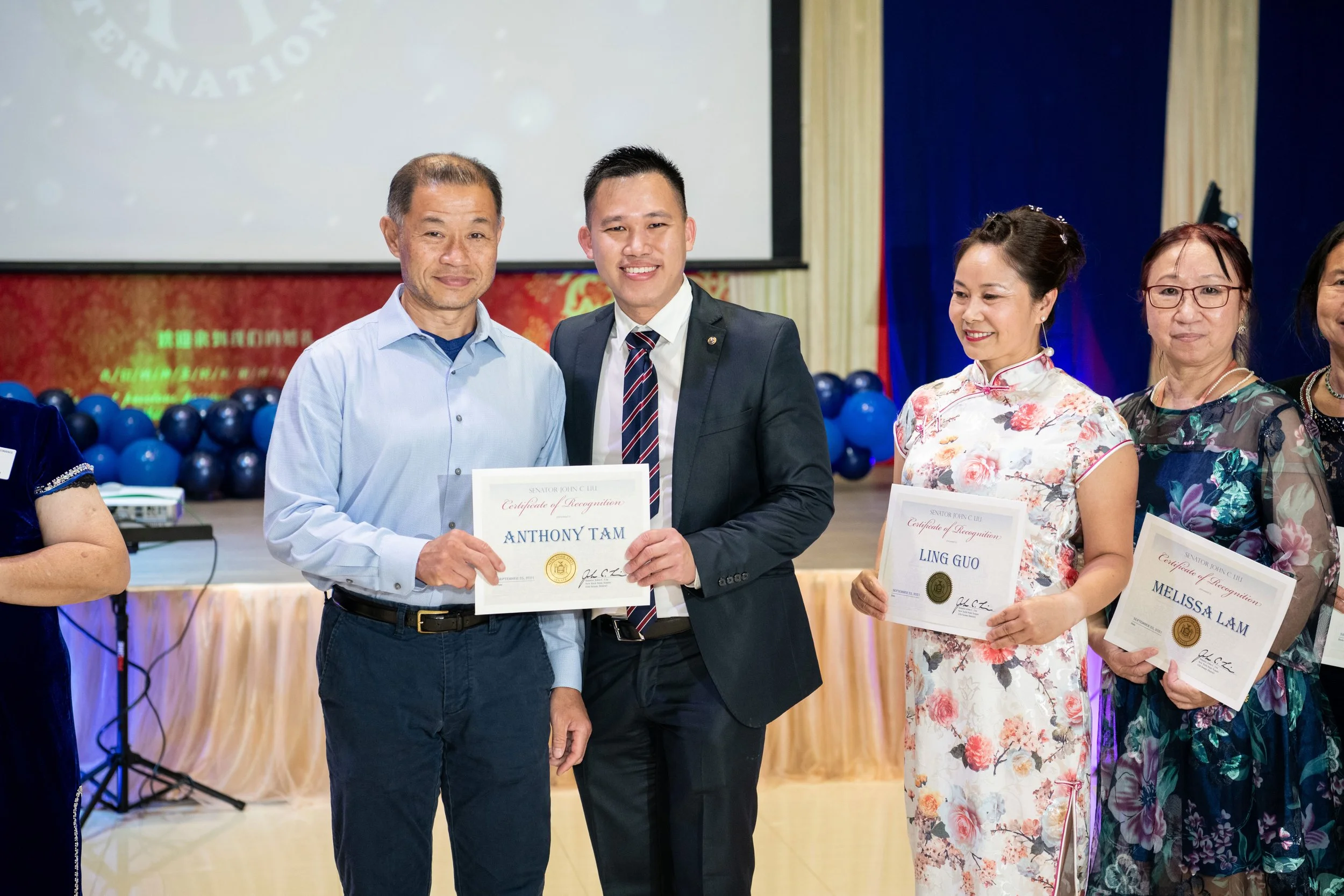 Recipients display certificates of recognition from New York Senator John Liu during a local community award ceremony.