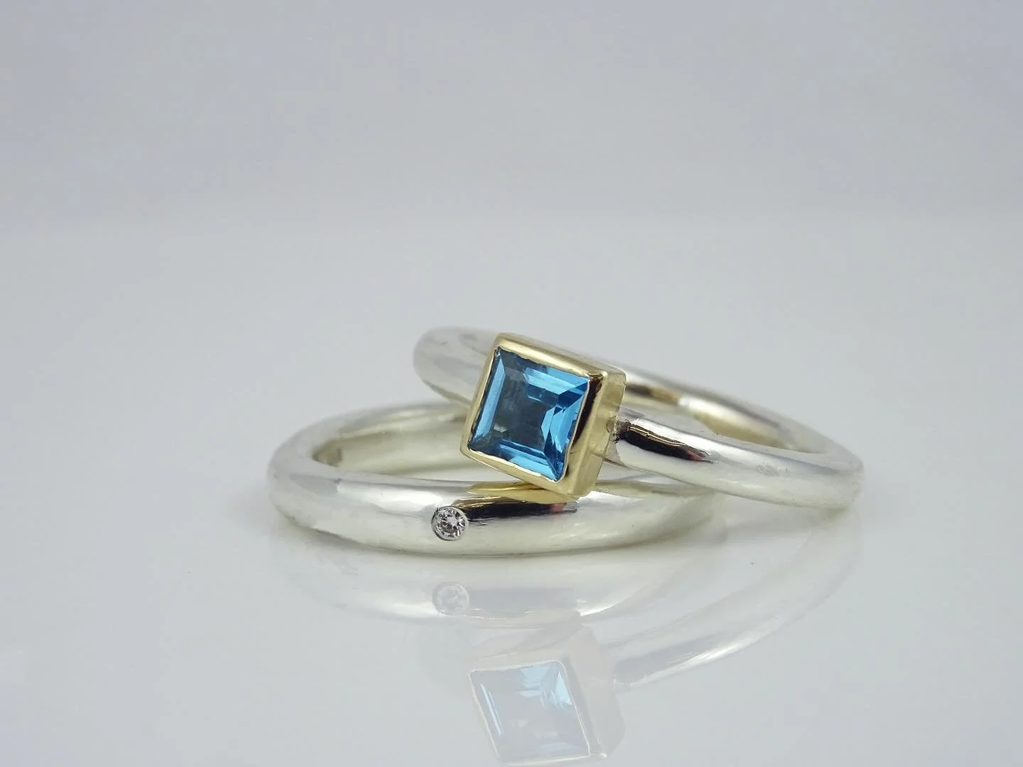 A beautiful Topaz and Diamond Engagement &amp; Wedding Ring set made for client whose rings had lost a stone and had get cut off

We brought these sentimental rings back to life with a pop of colour in the Swiss blue topaz set in yellow gold