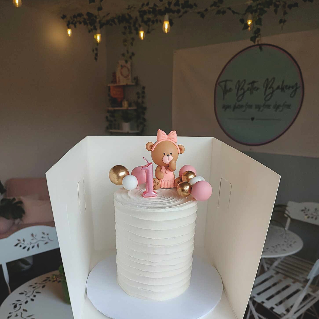 #87. This is a 4" round, 3-layer 1st birthday cake with a ribbed pattern and custom decor.