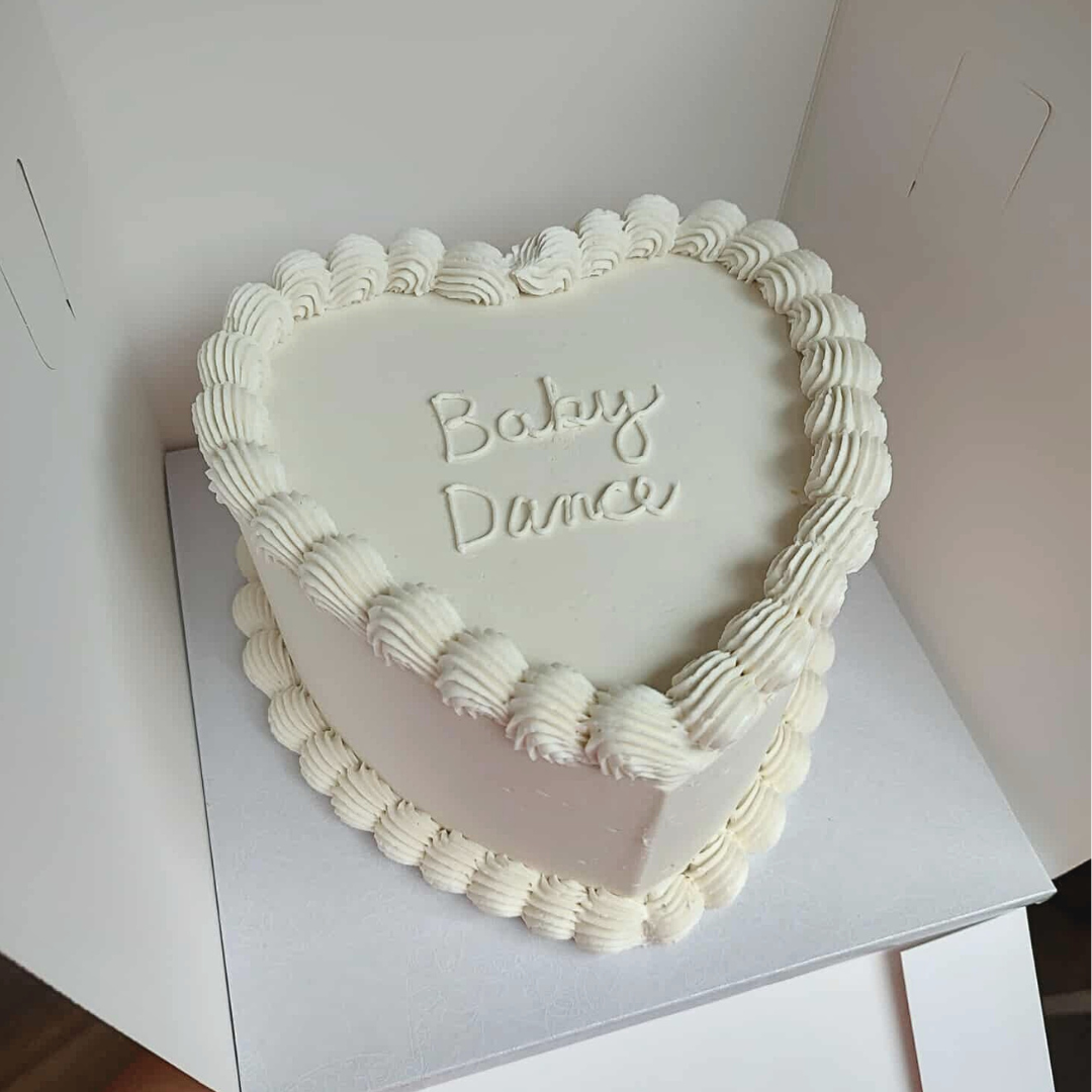 #100. This is a 6" heart-shaped, 3-layer gender reveal cake with a top and bottom shell border.