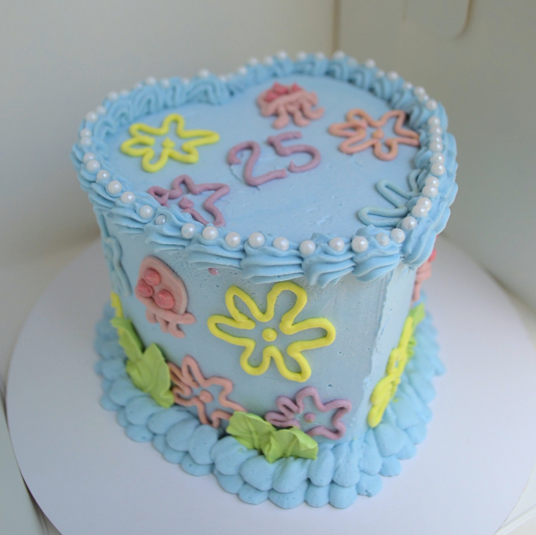 #67. Custom ocean-inspired heart-shaped cake.