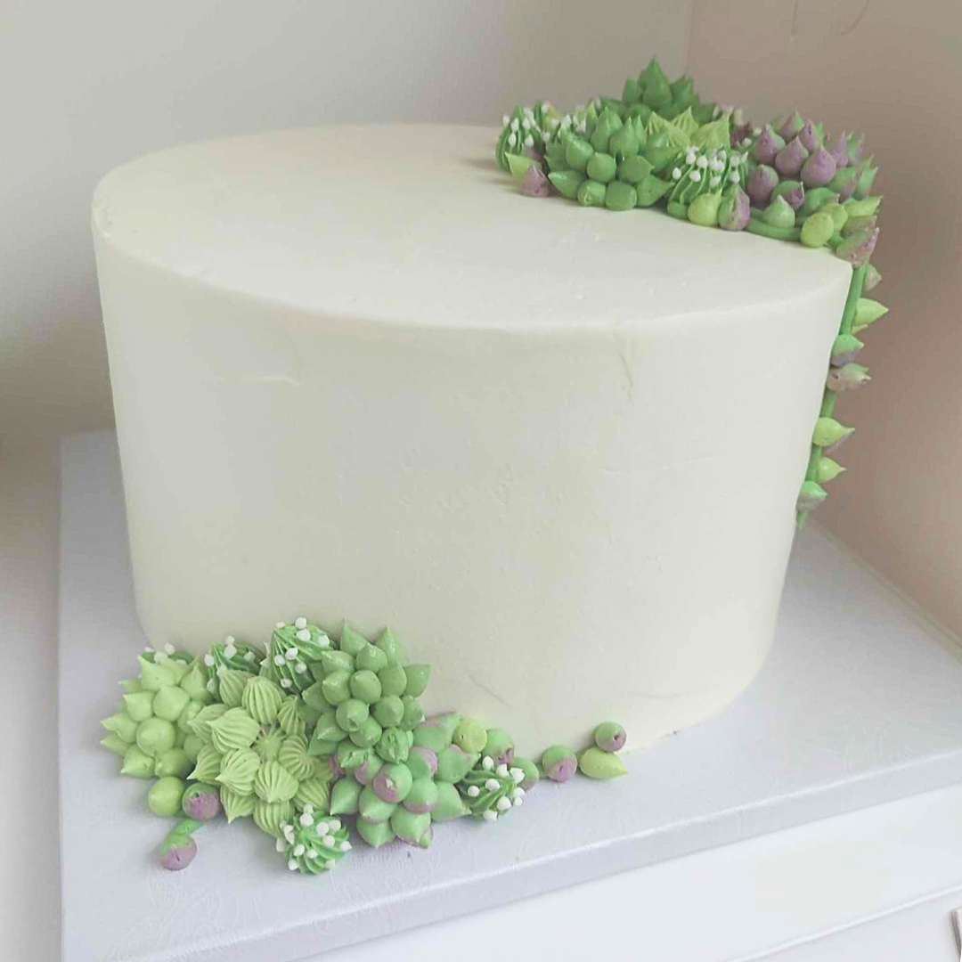 #110. This is a 6" round , 3-layer vanilla cake with hand-piped succulents.