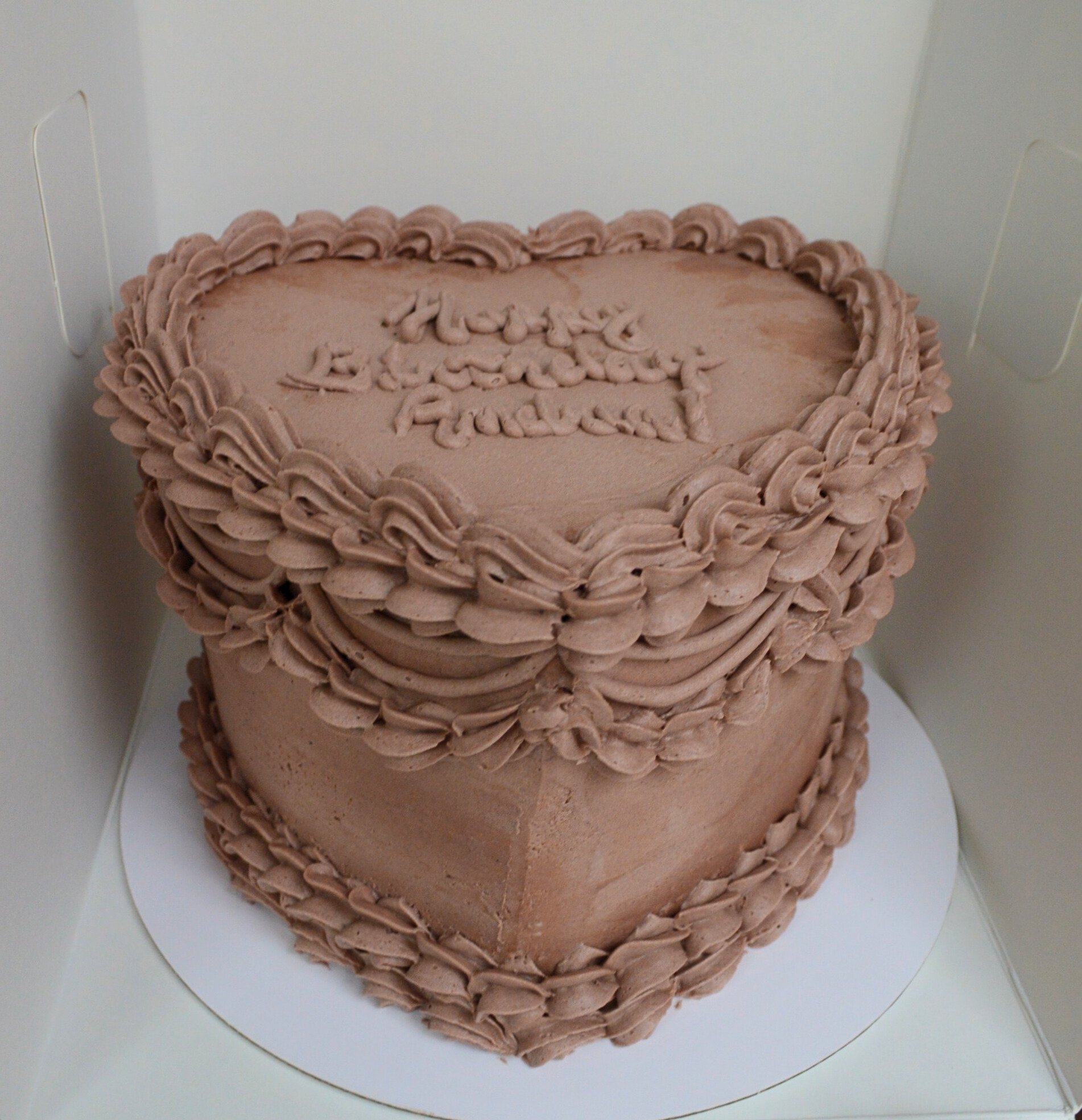 #72. Heart-shaped chocolate vintage style cake with a custom message piped on top.