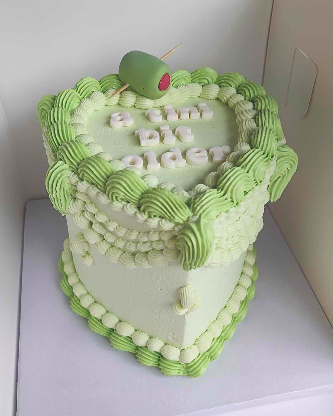 #17. This is a 6" heart-shaped, 3-layer martini-themed vintage-style cake.