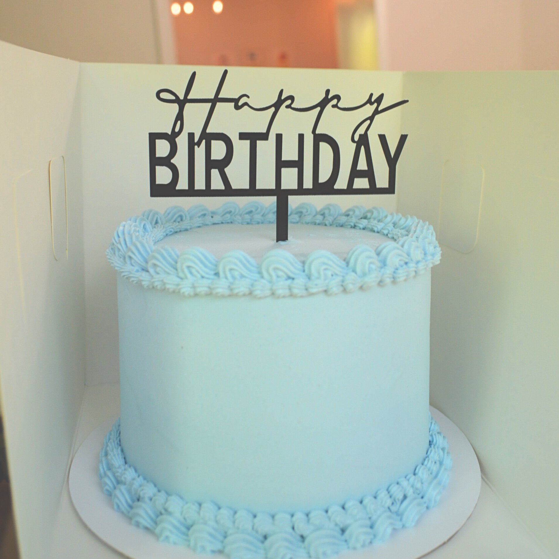 #64. Blue 6" round, 3-layer cake with a double top and bottom border and a black "Happy Birthday" topper.
