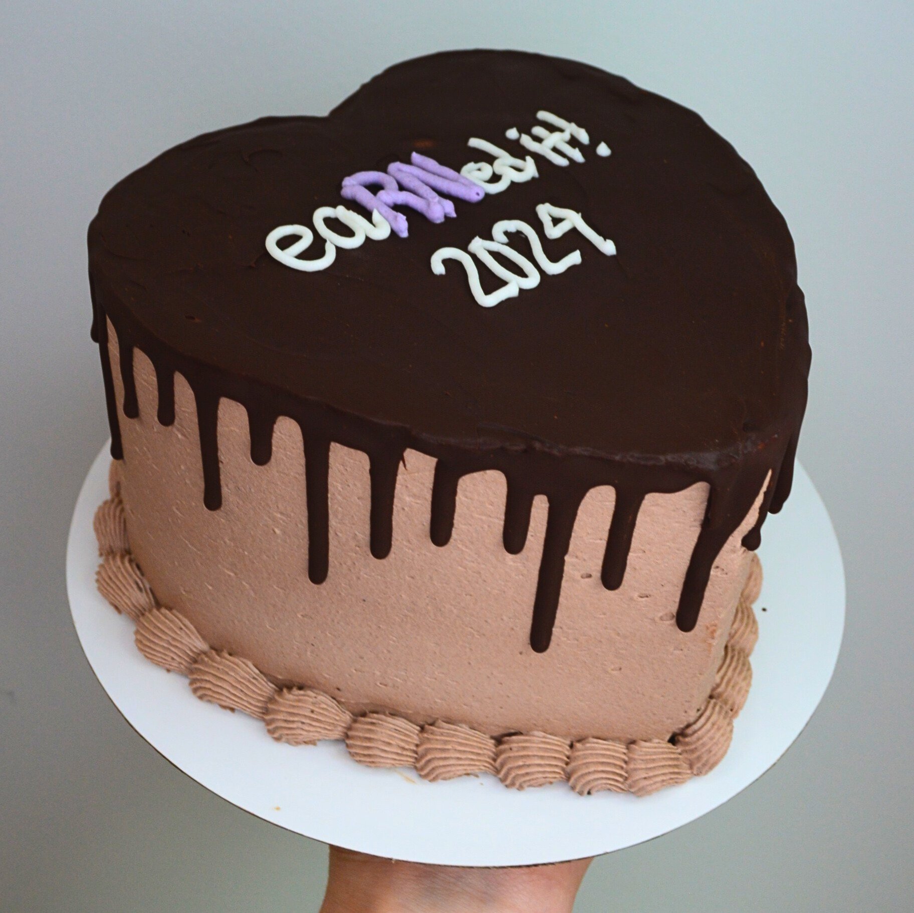 #23. Chocolate graduation cake with a dark chocolate drip and a custom message.