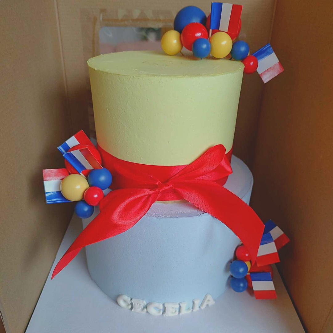 #88. This is a two-tiered Madeline-inspired cake. The sizes of the tiers are an 8" round, 3-layer tier and a 6" round, 3-layer.