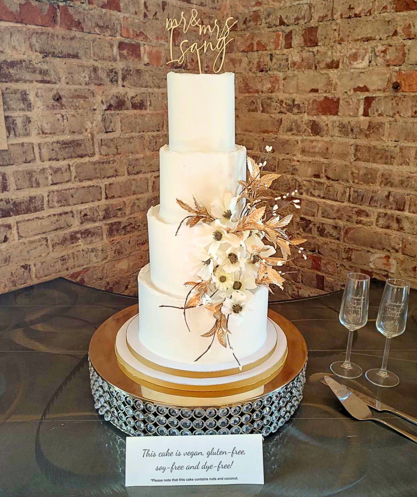 #7. Four-tiered wedding cake with natural top ridges, custom-made faux florals, a custom topper and a custom cake drum.