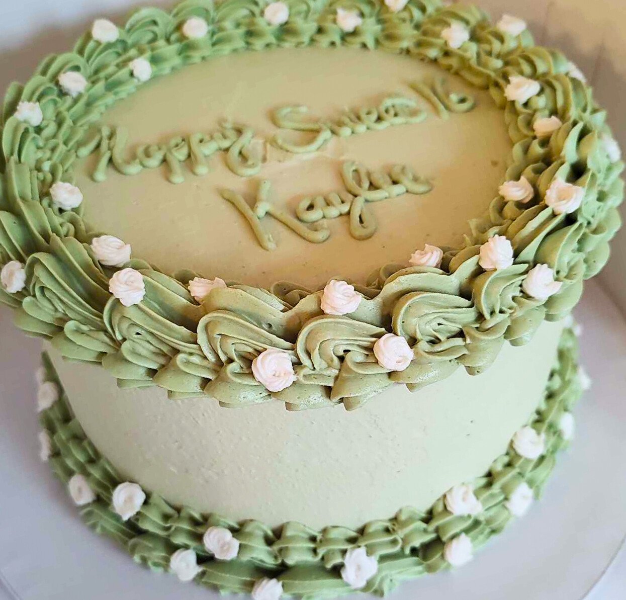 #14. Partial vintage style cake with small, white rosettes.