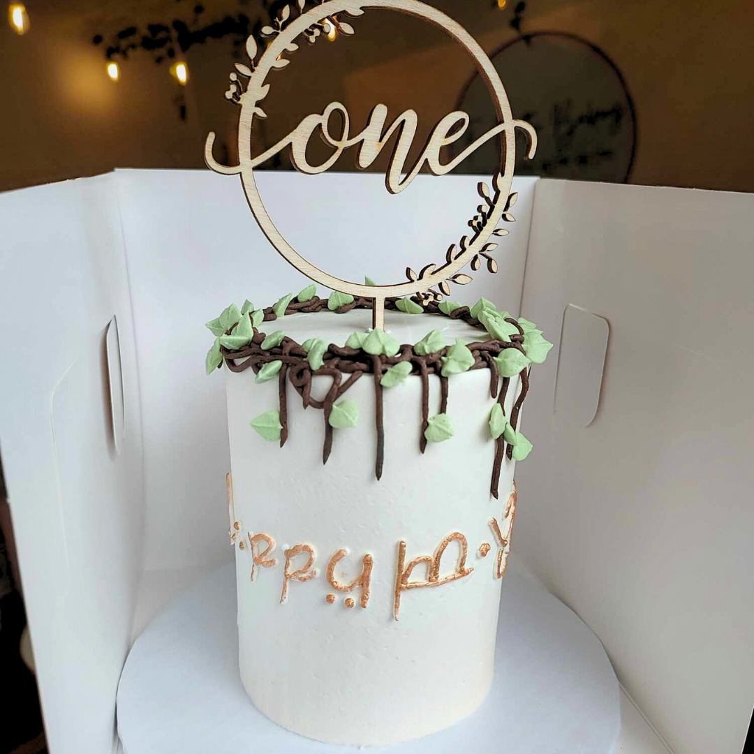 #111. This is a 4" round, 3-layer Lord of the Rings inspired cake with gold Elvish writing around the outside of the cake.