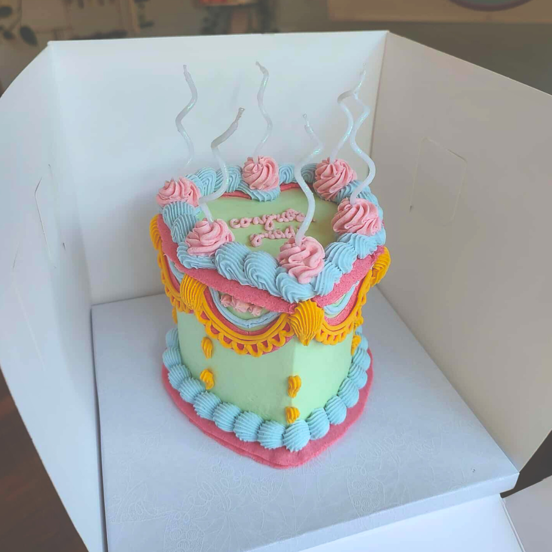 #16. This is a 4" heart-shaped, 3-layer multicolored vintage style cake.