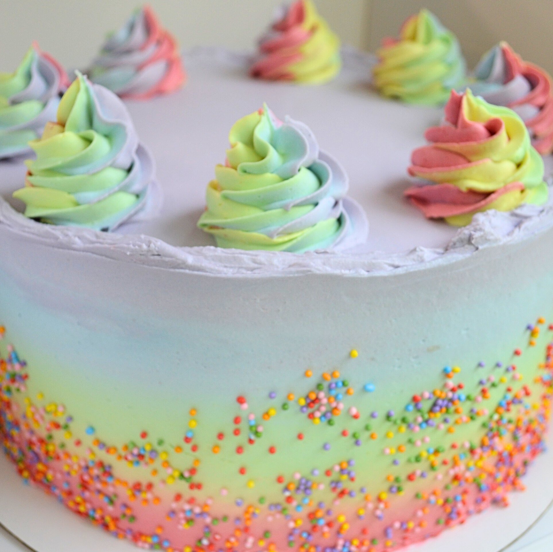 #26. Rainbow ombre cake with rainbow swirls and rainbow sprinkles.