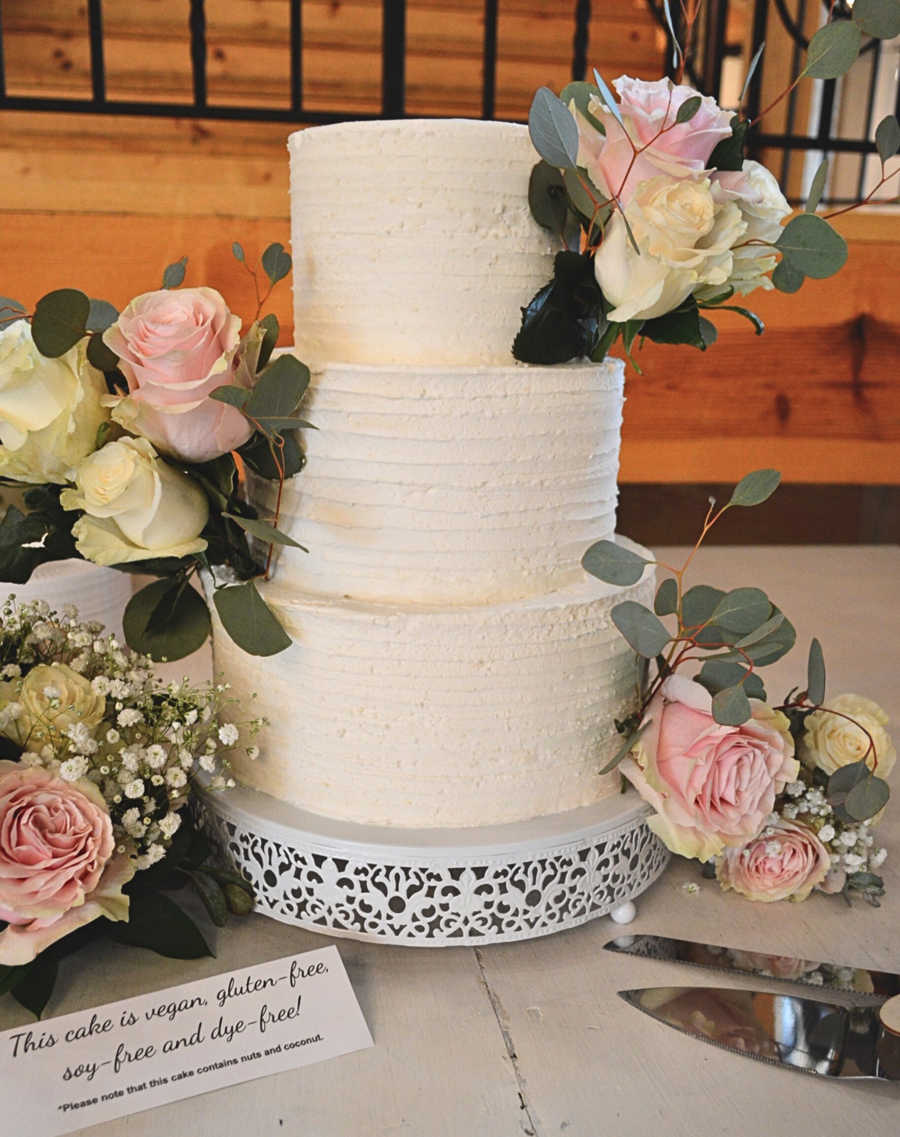 #51. Three-tiered coconut wedding cake with a horizontal ribbed pattern