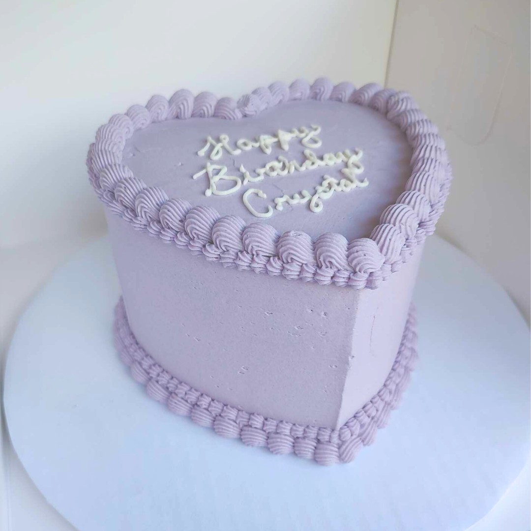 #104. This is a 6" heart-shaped, 3-layer cake with a double shell border on the top and the bottom.
