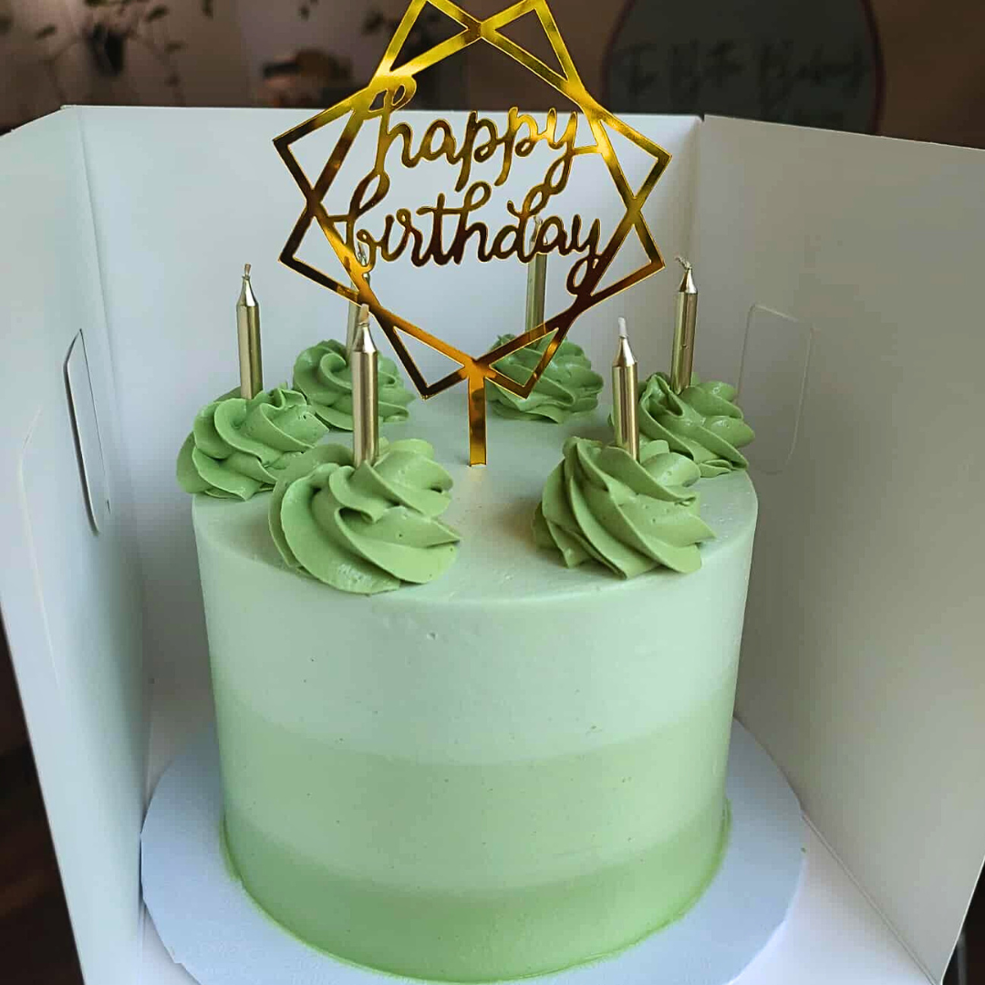 #95. This is a 6" round, 3-layer multi-colored green cake with frosting swirls, candles and a topper.