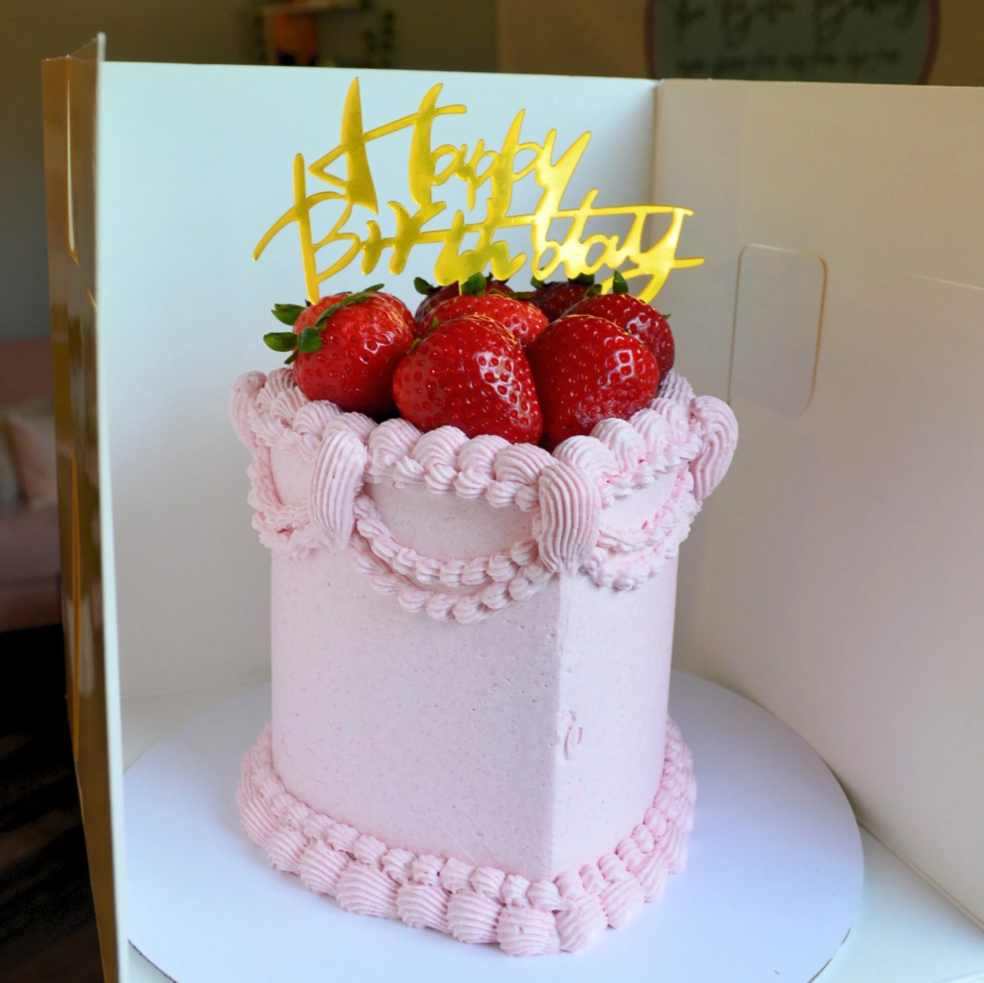 #124. This is a 4" heart-shaped, 3-layer pink strawberry vintage style cake with fresh, organic strawberries.