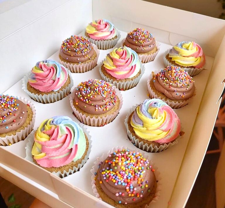 #5. Assortment of cupcakes with rainbow swirls and chocolate frosting with rainbow sprinkles.