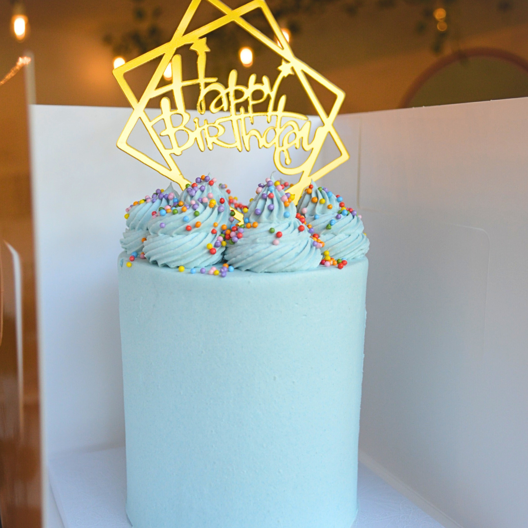 #114. This is a 4" round, 3-layer light blue cake with rainbow sprinkles.
