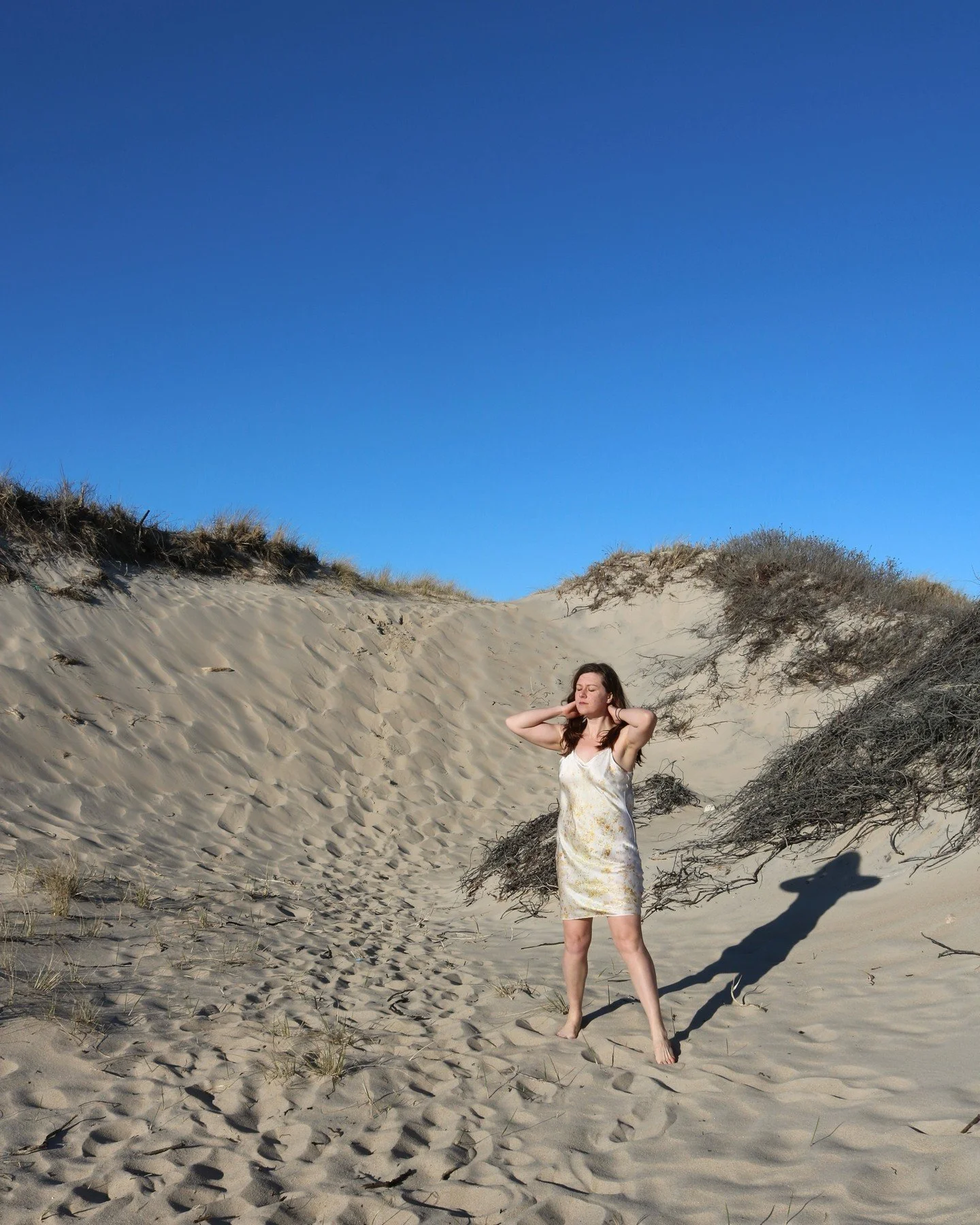 When your dress matches the beach 🌊🌊🌞🌞 The Zinnia dress dyed with hopi sunflower seeds and onion skins is a dreamy white with playful bursts of yellow. #natureinspired #Florawearco #sustainablefashion #florawearco #silkdresses