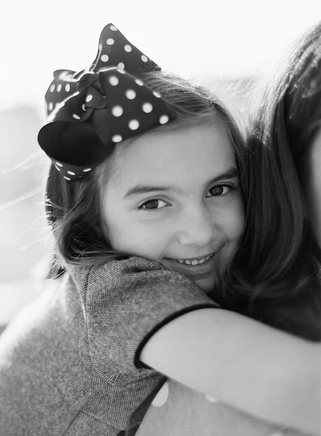 Sweet mother daughter portrait captured on black and white film