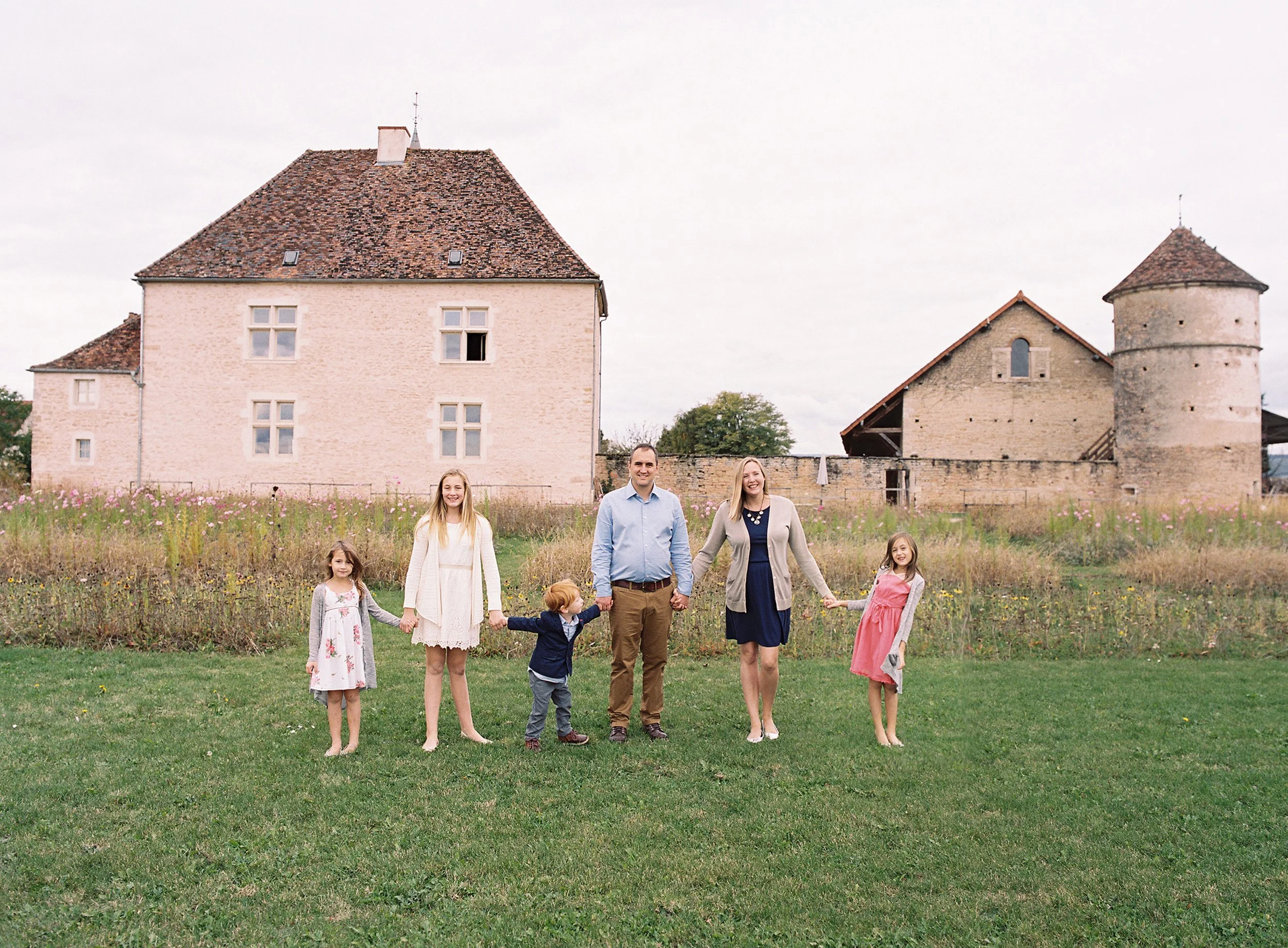Portrait of a family on holiday in a rustic farmhouse setting in Burgunday France