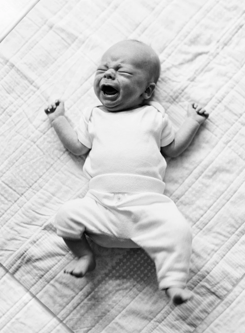 black and white portrait of a newborn baby crying