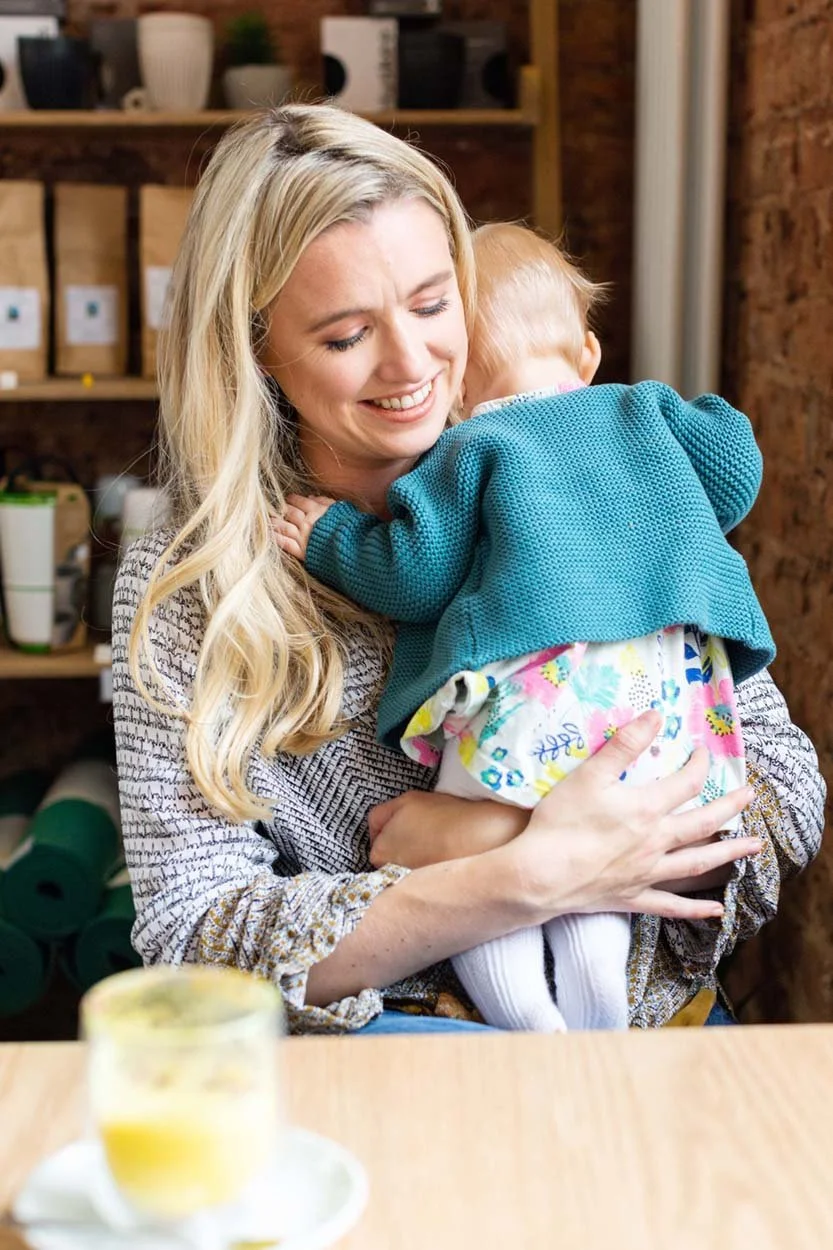 Natural brand portrait of a dr and mumfluencer with her baby