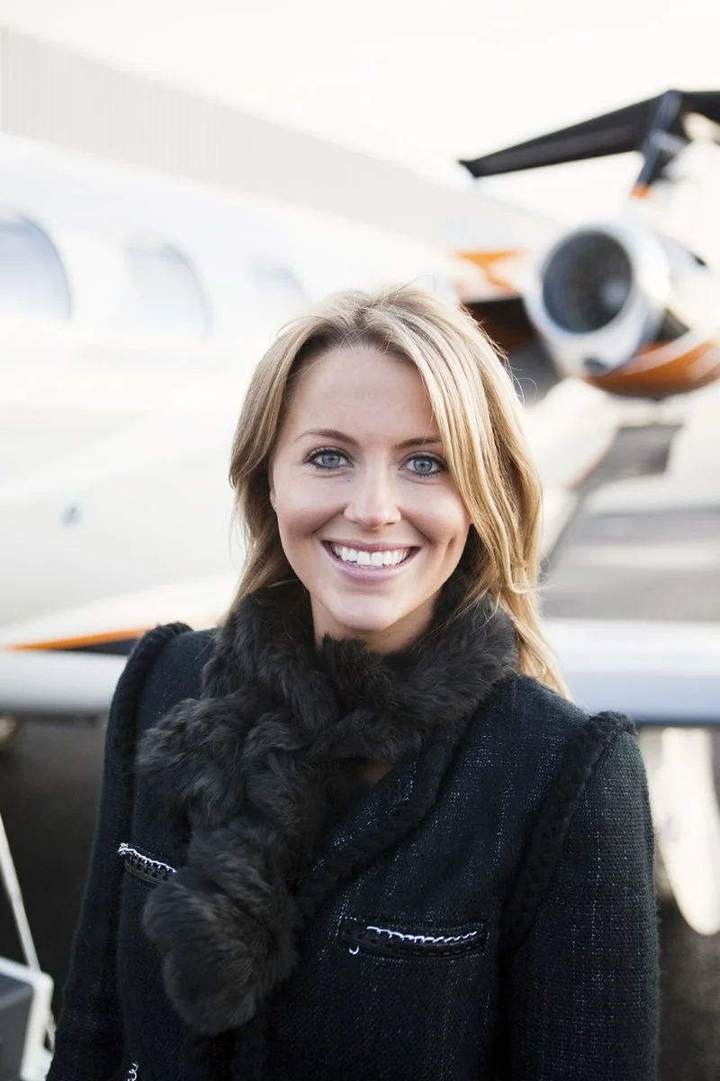 Personal brand portrait of a woman in front of a private jet