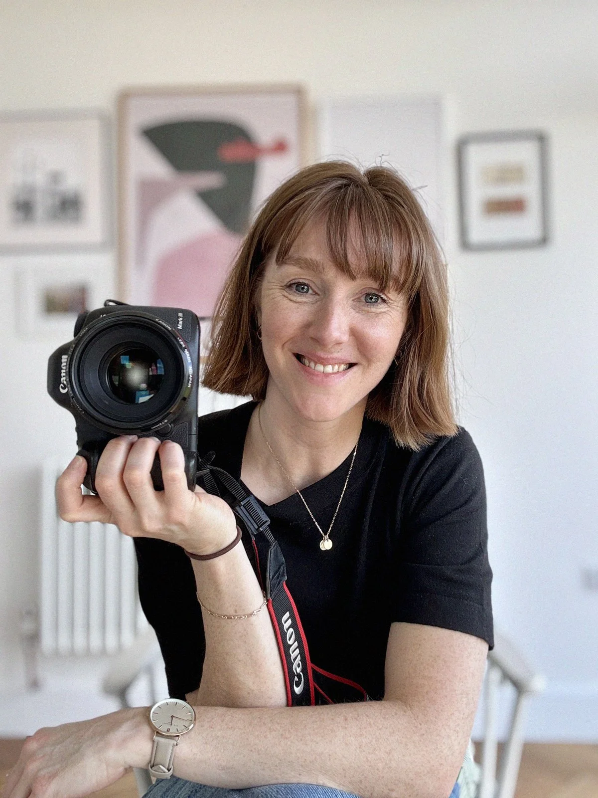 Personal brand photographer Victoria Phipps posing with her camera