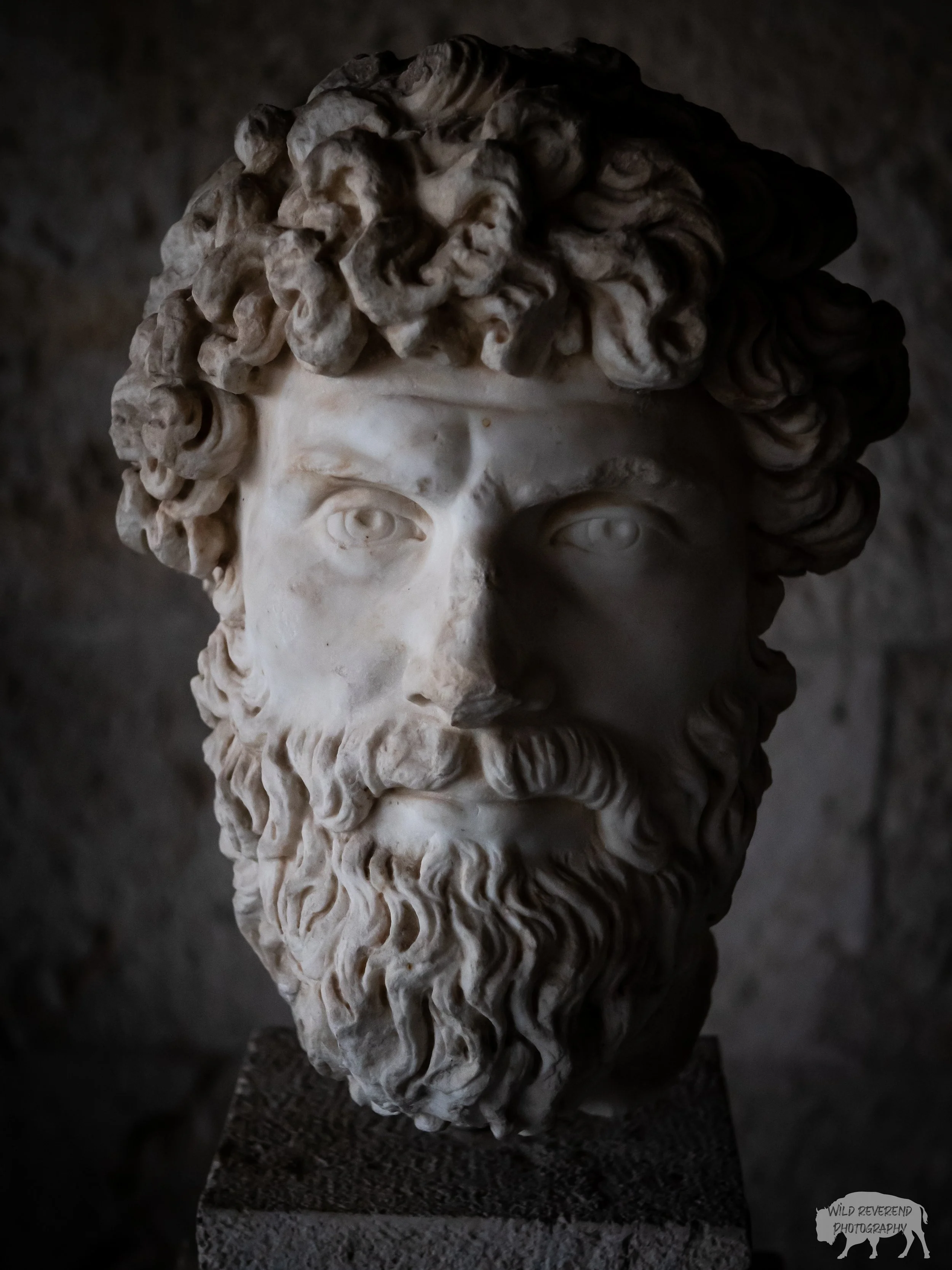 A carving from Athens of a mans head. May be Poseidon.