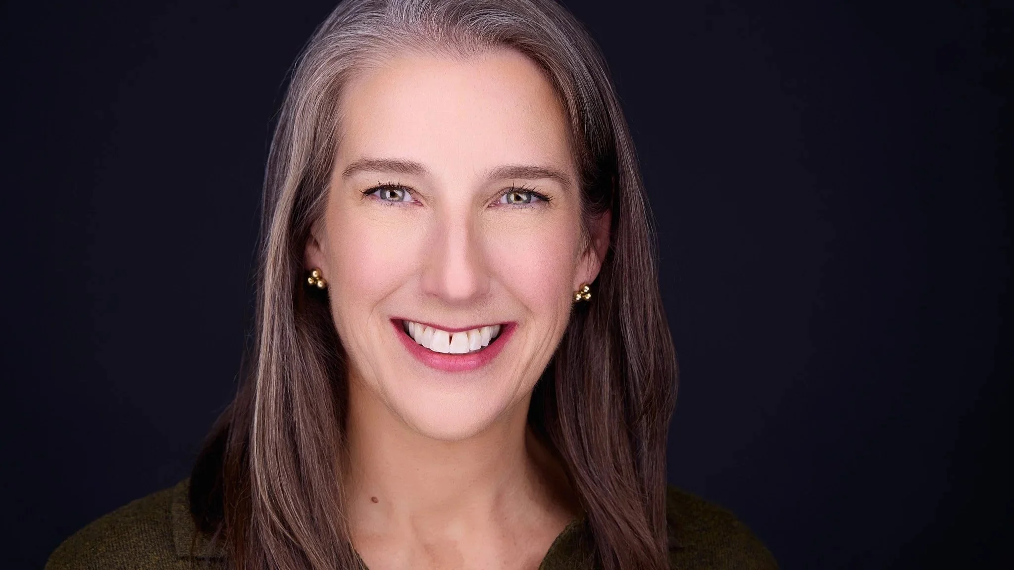 Professional headshot with a confident, approachable expression.