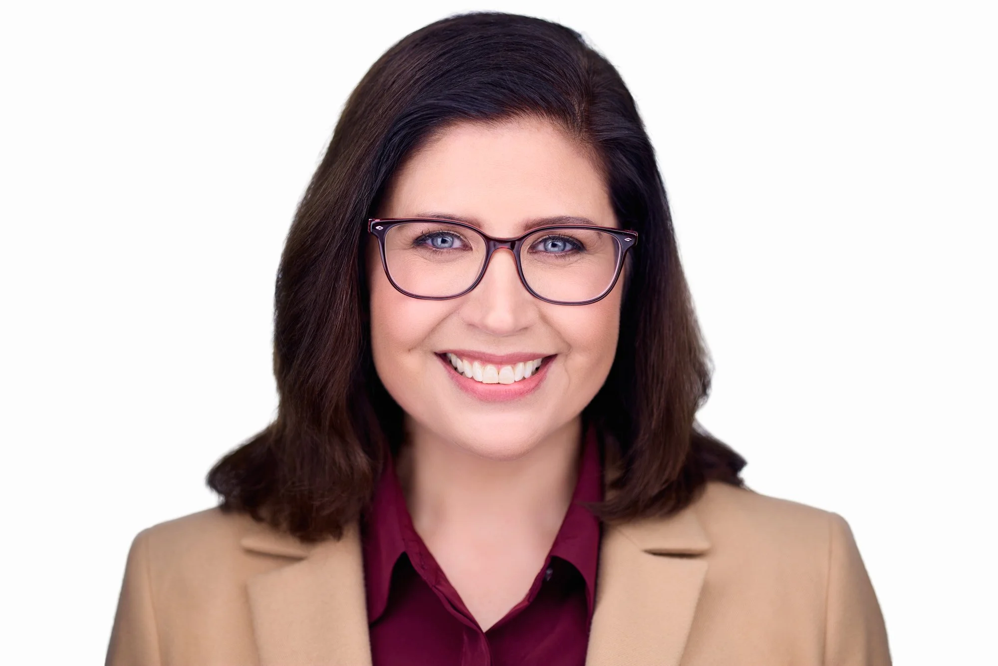 Facial expression coaching guiding a professional to project confidence and approachability in a headshot.