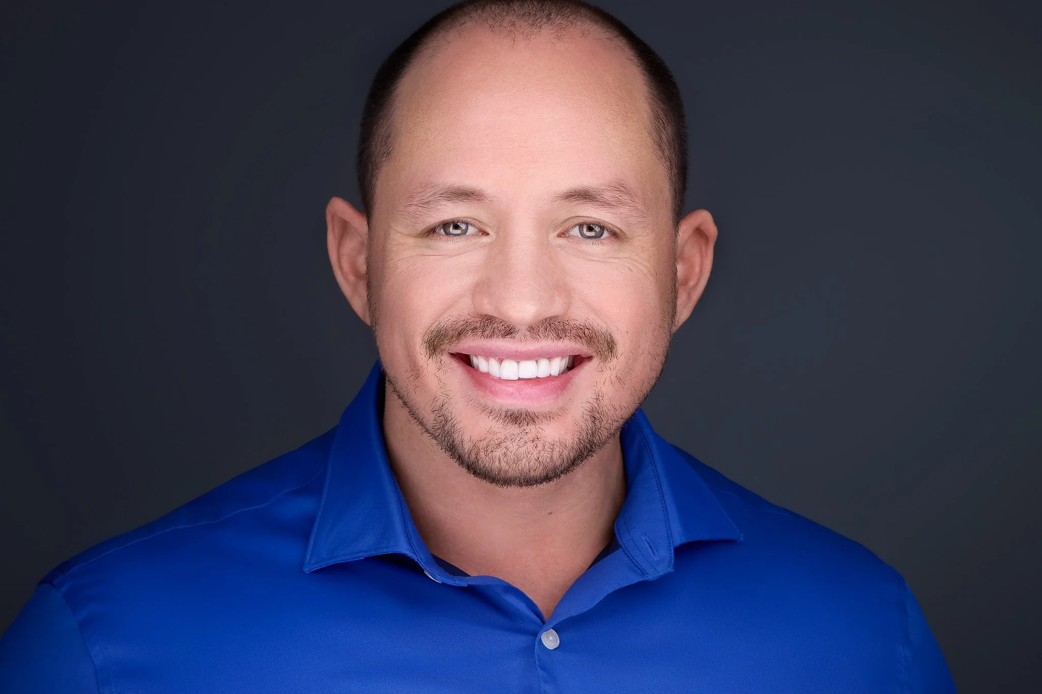 Professional headshot with a friendly, approachable expression.