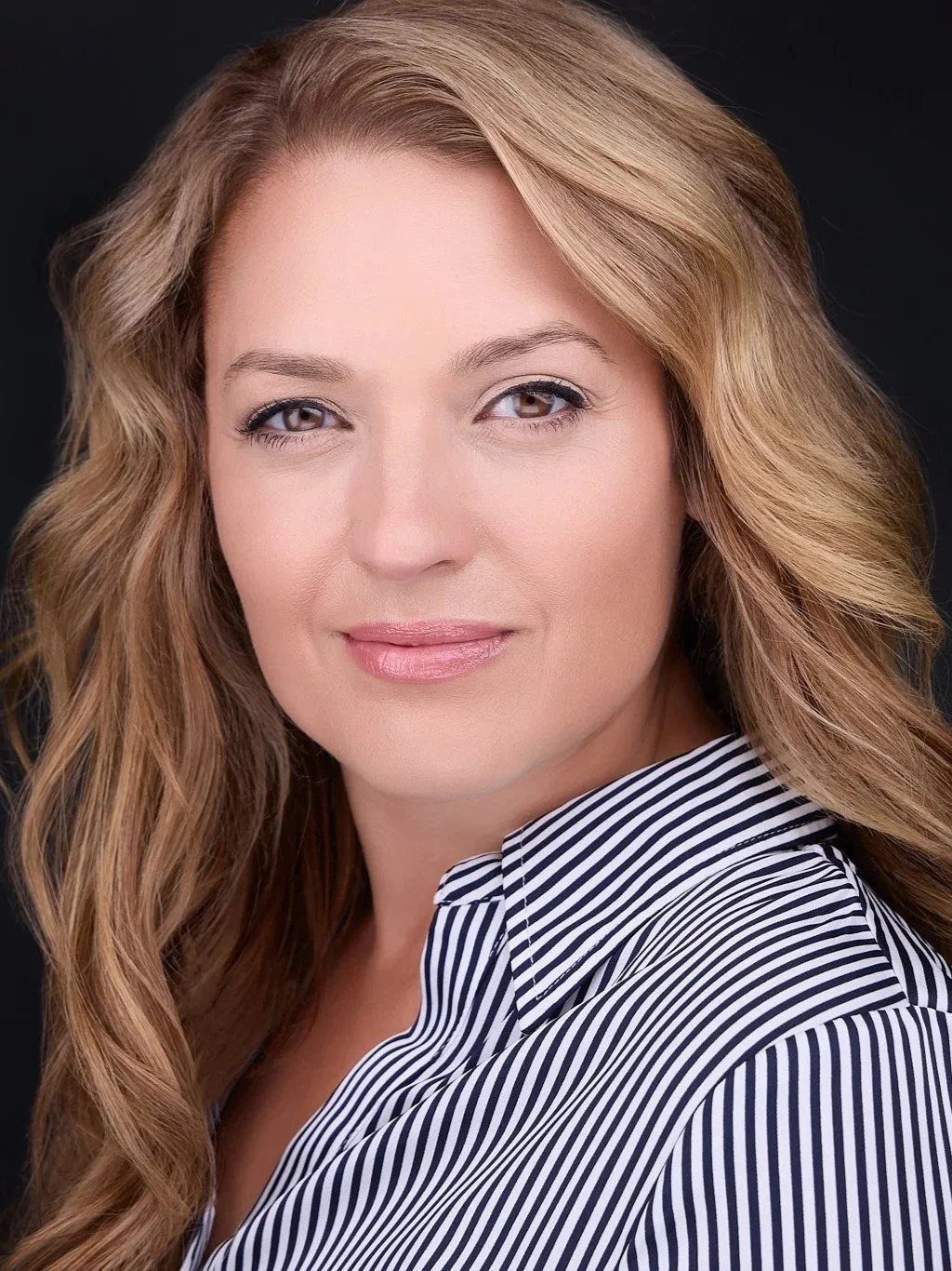 Personal brand portrait with a composed expression and professional presence.