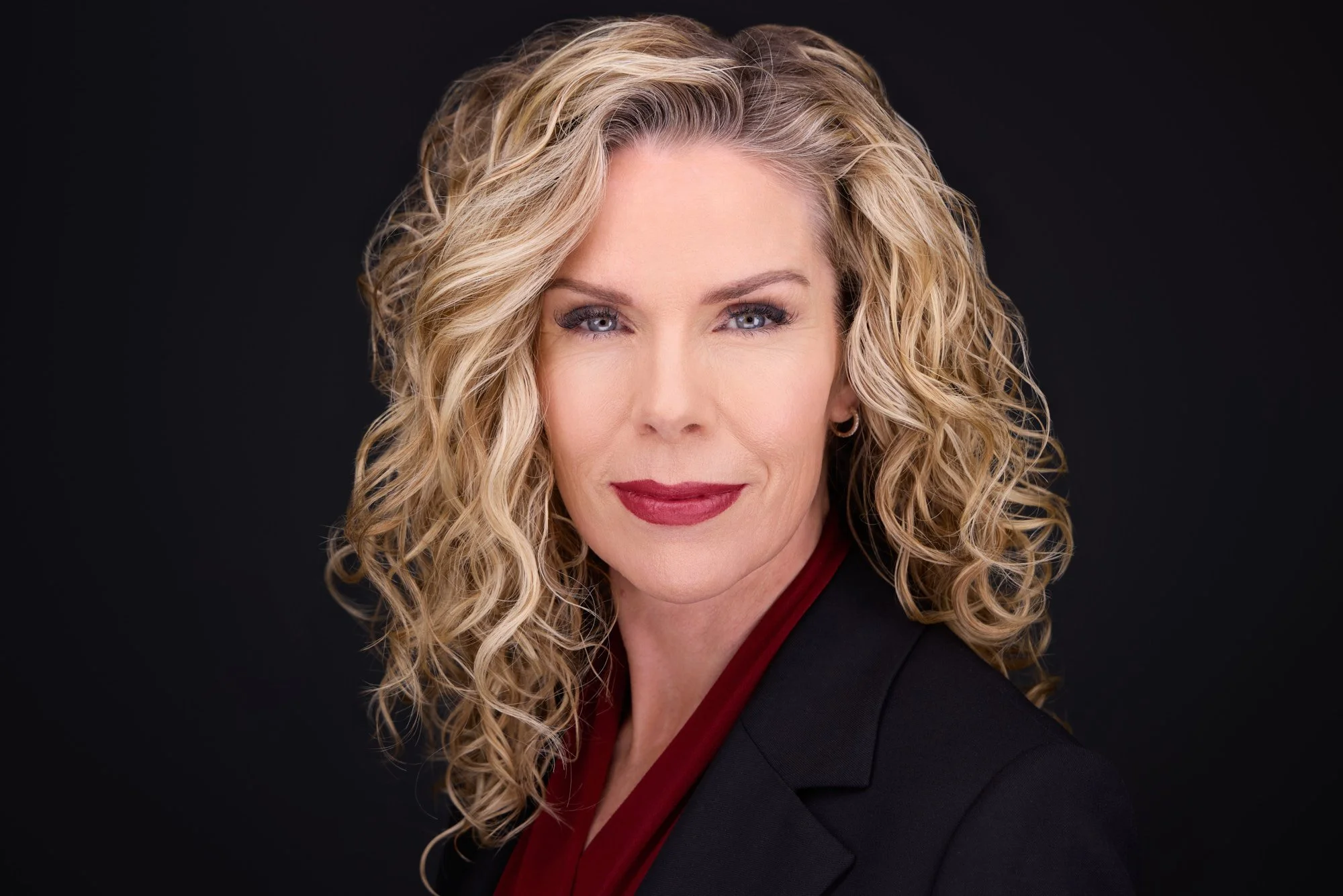 Professional displaying calm, confident leadership presence in a headshot.