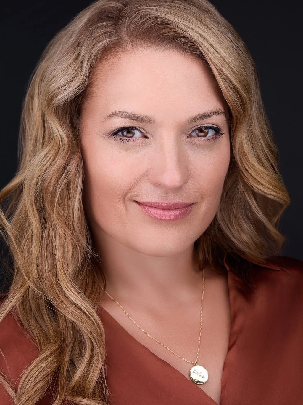 Personal brand portrait with a composed, confident expression.