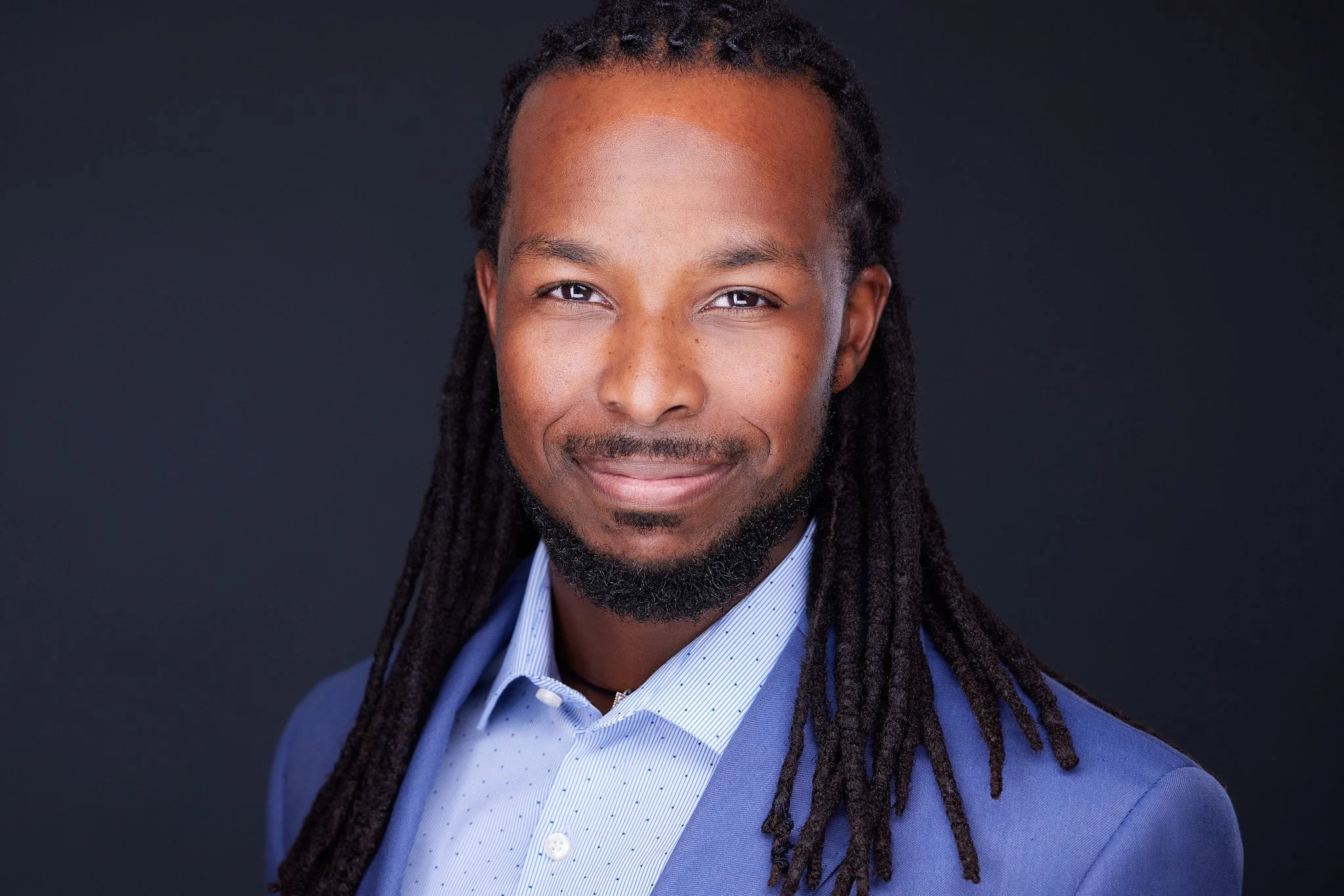 Professional headshot with a confident, approachable expression.