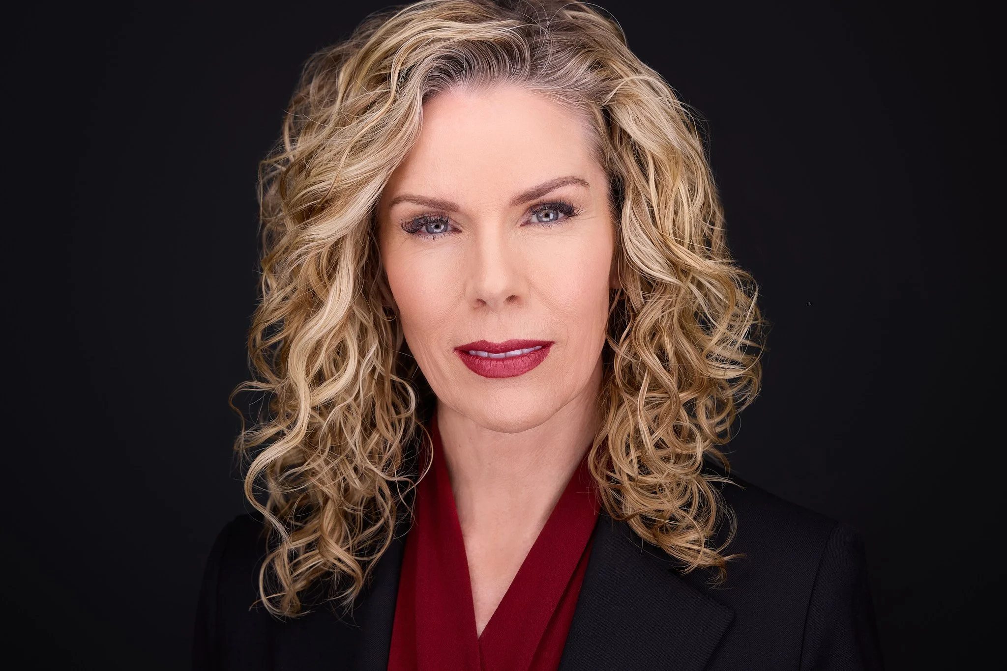 Professional headshot with a composed, confident expression.