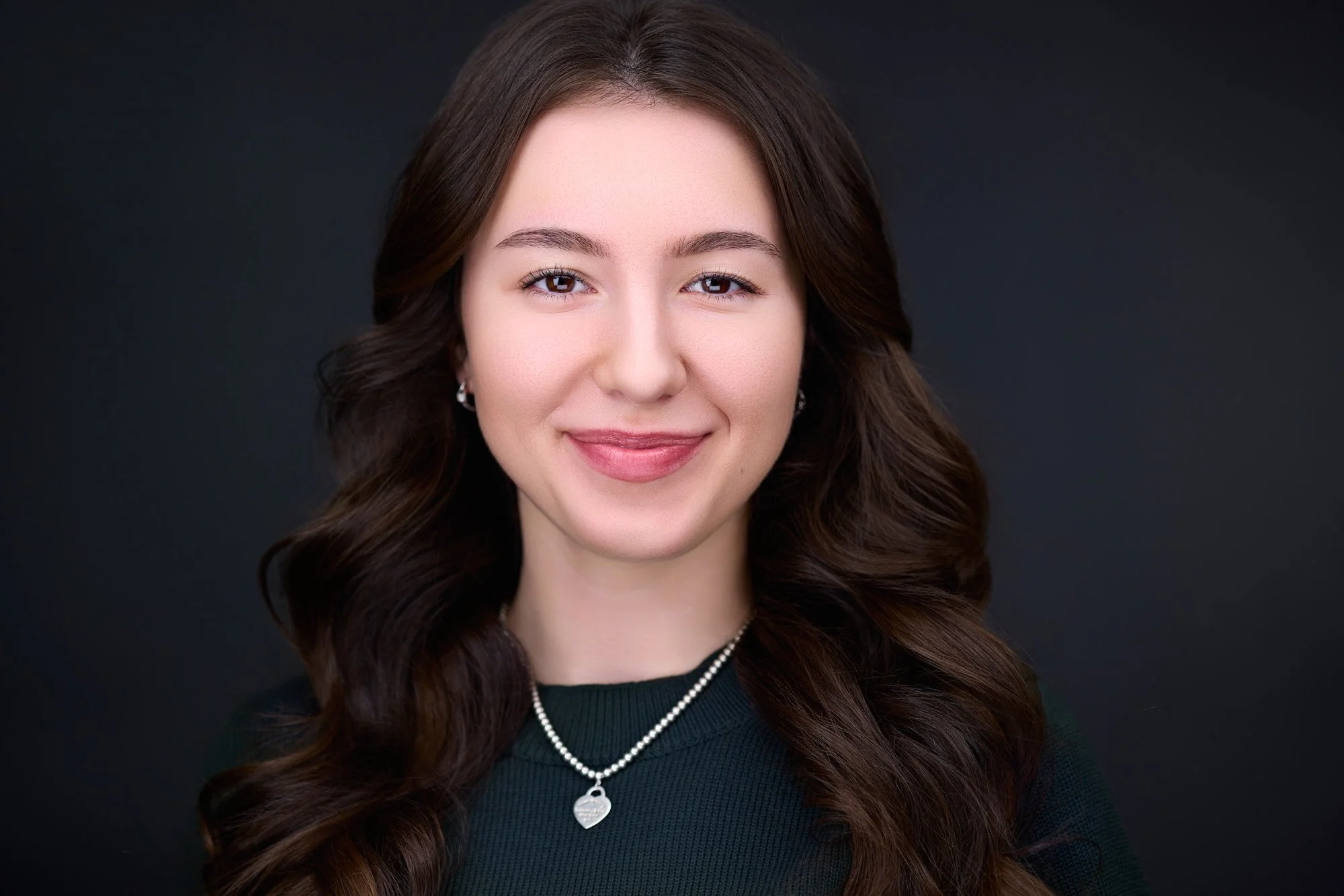Professional being guided during a headshot session rather than posed.