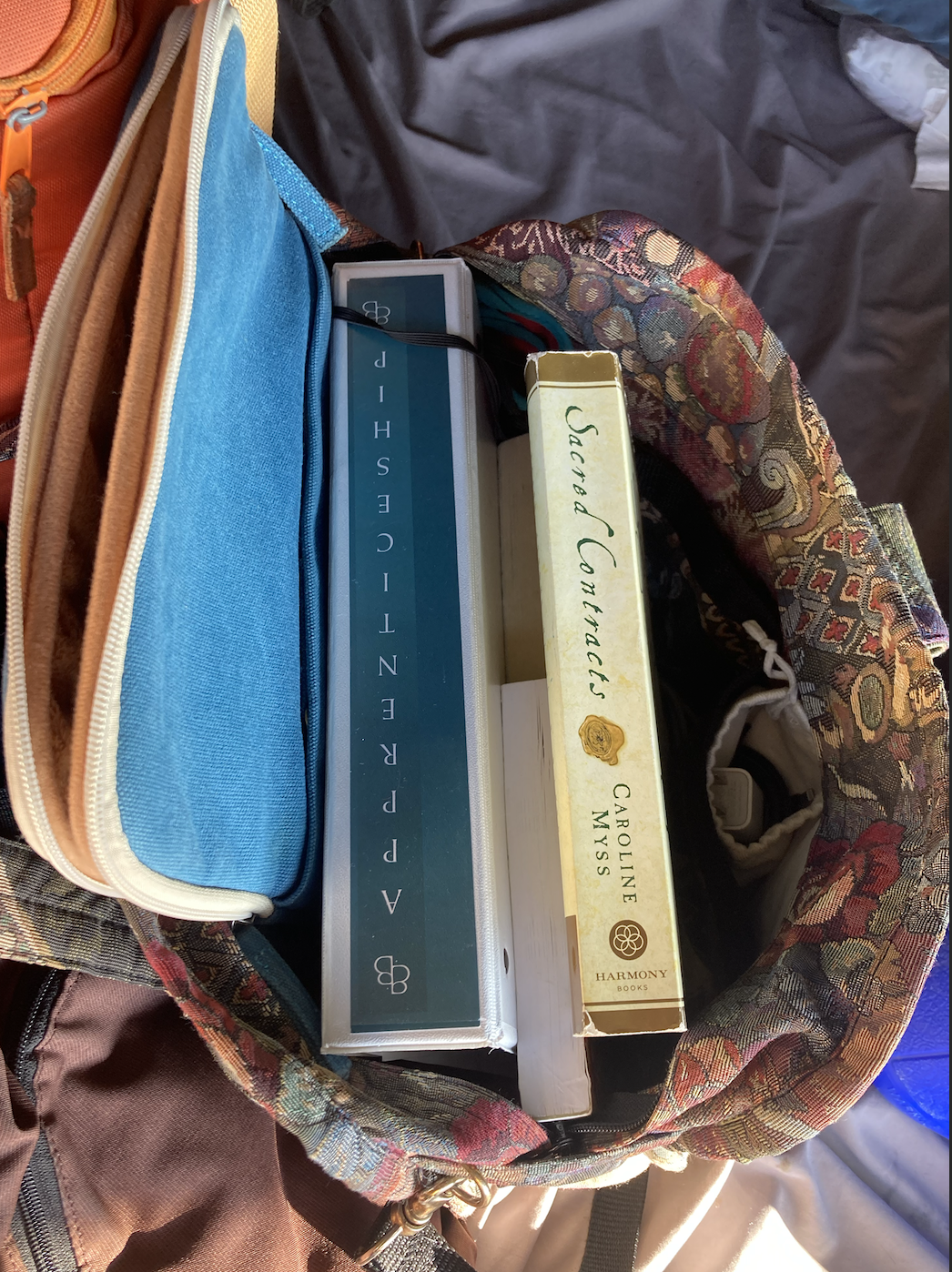 Doula Dyson’s doula bag with Britta Bushnell’s apprenticeship binder and Soul Contract by Caroline Myss