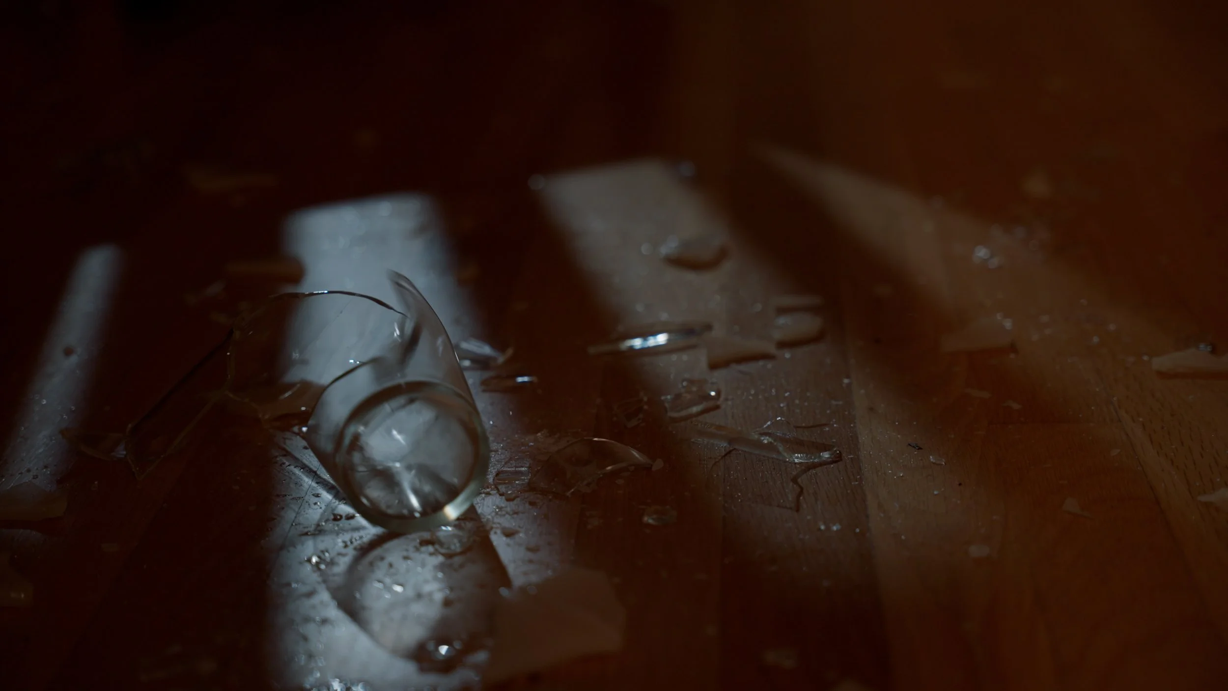 Shattered glass on wooden floor