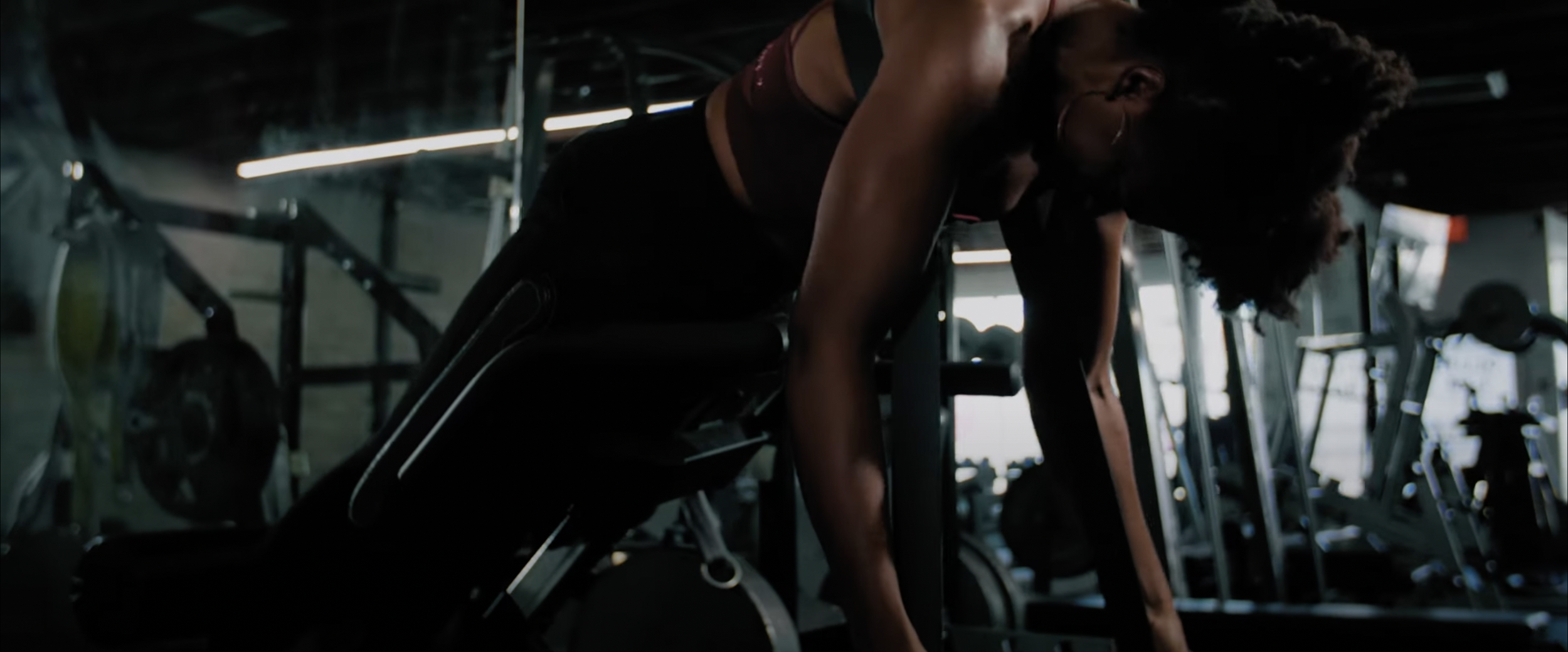 Person working out on a hyperextension bench in a gym