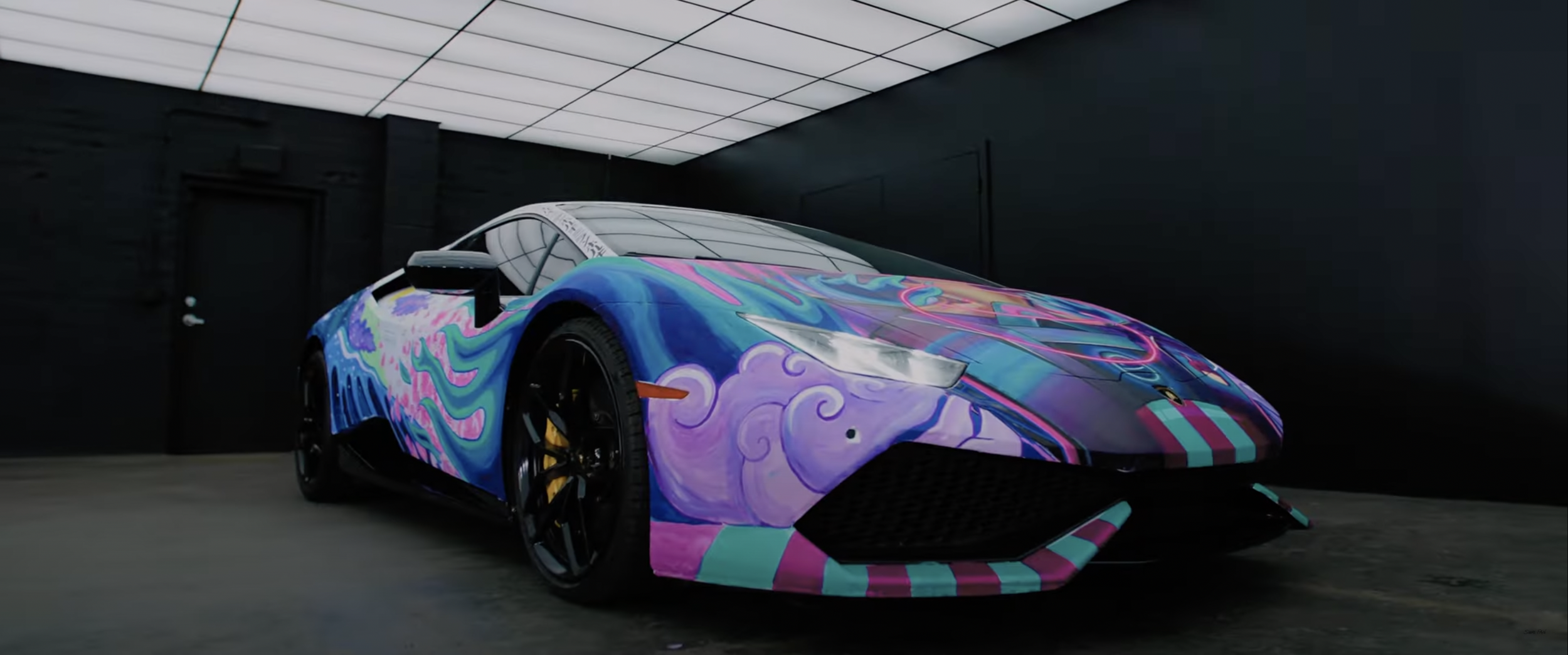 Colorful Lamborghini with abstract art in a dark room